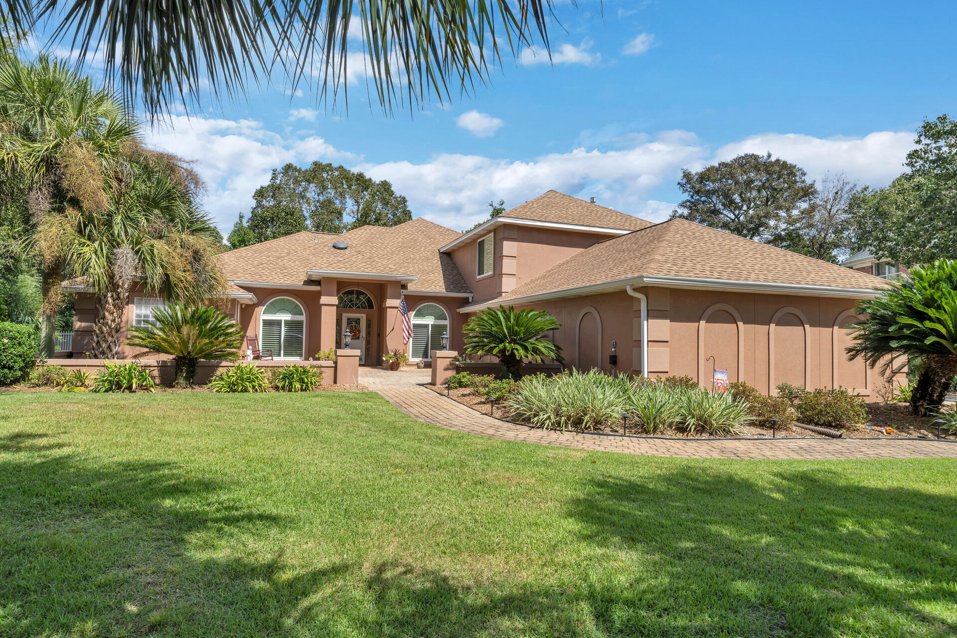 Absolute jaw-dropping custom home sits on the massive lot in the secluded 'Glenlake' subdivision of Bluewater Bay and was built to entertain! This beauty features a desirable split floor plan with a huge first floor master suite with tray ceilings, sitting area and a gorgeous newly remodeled bath with sliding barnyard closet doors, custom built-in closets, garden tub, dual vanities, and massive walk-in rain shower! The enormous gourmet dream kitchen with brand new SS appliances, granite counters, endless cabinetry, large snack bar, wet bar, wet coffee bar, center island, breakfast nook with brand new hurricane bay windows, wine cooler and a pot filler!  Enjoy the stunning views of the completely resurfaced and redesigned salt gunite pool, reglassed spa, and custom-extended enclosed lanai!