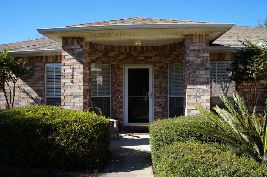 BEAUTIFUL MOVE-IN READY 3 bedroom, 2 bath home in Woodlands Estates with a 4TH bonus room! Use as a den, study, office! Low maintenance ALL brick home. Large great room with split bedroom floor plan. Home has new gorgeous hardwood laminate flooring through the living areas. Kitchen, bathrooms and laundry areas are all tiled. No carpet! Kitchen has eat-in area with a big bay window. Center island with TONS of storage/cabinet space. Master Bath has double vanity, walk-in 42'' x 26'' shower, garden tub, 2 walk-in closets - even a ceiling fan! Oversized Master Bedroom. Large enclosed Florida Room with sliding windows and screens. Outside covered patio area makes for the perfect grilling spot. All windows have anchors for fabric type hurricane panels except for the Florida room. See more