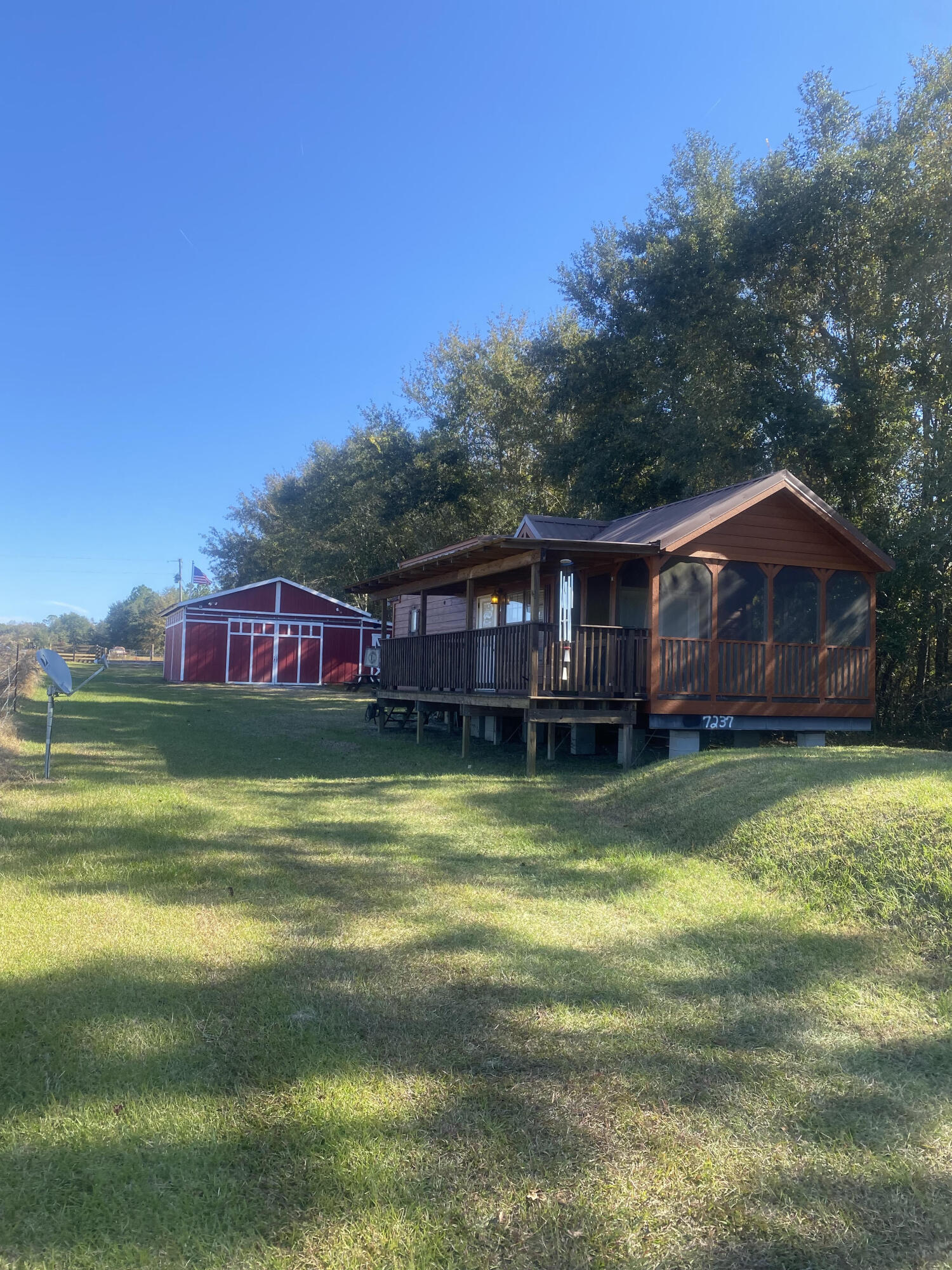This is is the getaway you've been waiting for! 102 acres in North Walton County with a tiny home, also referred to as a Cabin on Wheels, and barn. The cabin is built by Stone Canyon Homes in Brilliant, AL. It is the Echoe Model. Find more information at stonecanyonhomes.com. The barn has several separate storage areas, bathroom and bar area. Well, power and septic already in place. The majority of the property is mature hard woods with several trails cleared throughout for hunting, as well as beautiful home sites, if building was your goal. This is a must see to appreciate!Floor plan of cabin in Documents.