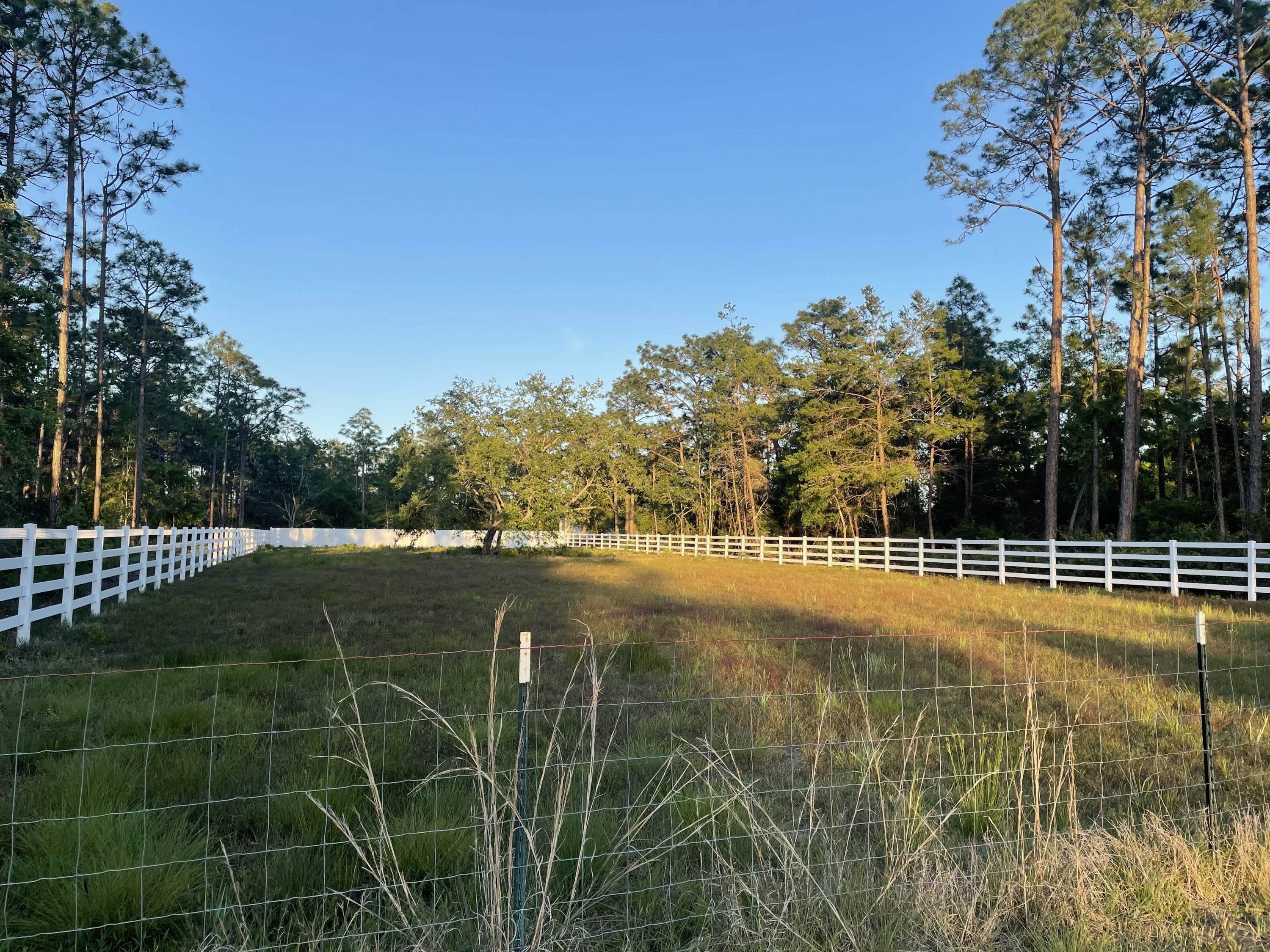 Beautiful lots selling both together as one. This 1.37 acres has one half cleared and fenced with beautiful white fencing while the other is all natural with tall gorgeous pines reaching for the sky! These lots are only minutes from the main happenings such as restaurants, retail shops, parks, and of course one of the worlds most beautiful beaches with sugar white sand and crystal clear waters. With over an acre, which is hard to find in this area, you can build a beautiful home and leave the natural lot as a buffer from neighbors or clear the underbrush and have gorgeous mother nature landscaping! A quick trip up Hwy 87 gets you right to the 1-10 Interstate for traveling. Call today for more information.