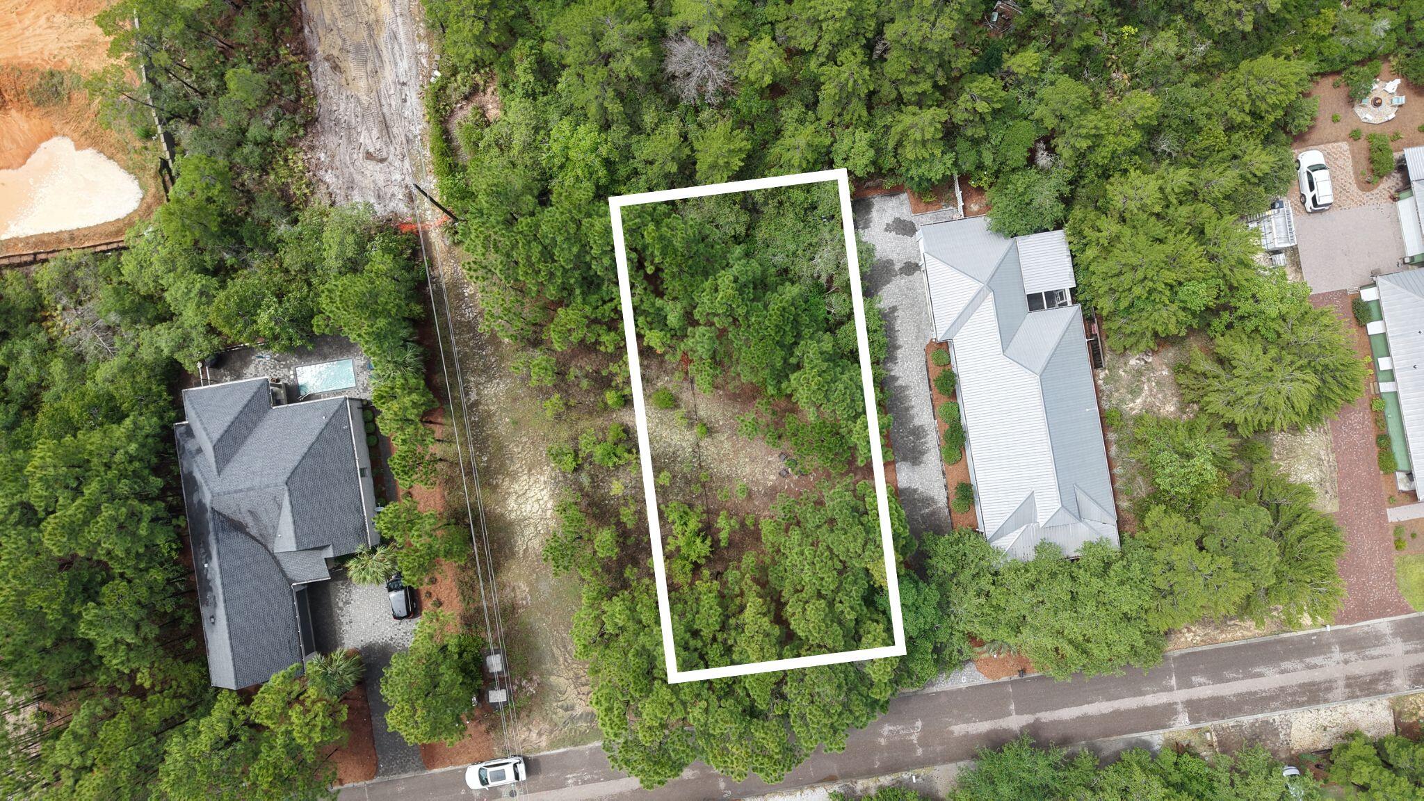 Welcome to one of the best-kept secrets on 30A's west ens: Spotted Dolphin Road. This prime lot is ideally nestled in a quiet, natural setting surrounded by mature pines and native vegetation, offering a rare blend of serenity and privacy just minutes from the sugar-white sands and emerald waters of the Gulf.Build your dream coastal retreat, a full-time residence, or a vacation rental--the possibilities are endless with no HOA and no build-out time. Tap fees have already been paid, providing added value and convenience.Bonus opportunity: A beautifully updated home is also available for sale right next door: see MLS #976207. Can be purchase together or separately for a rare chance to create a private compound or a dual investment opportunity.