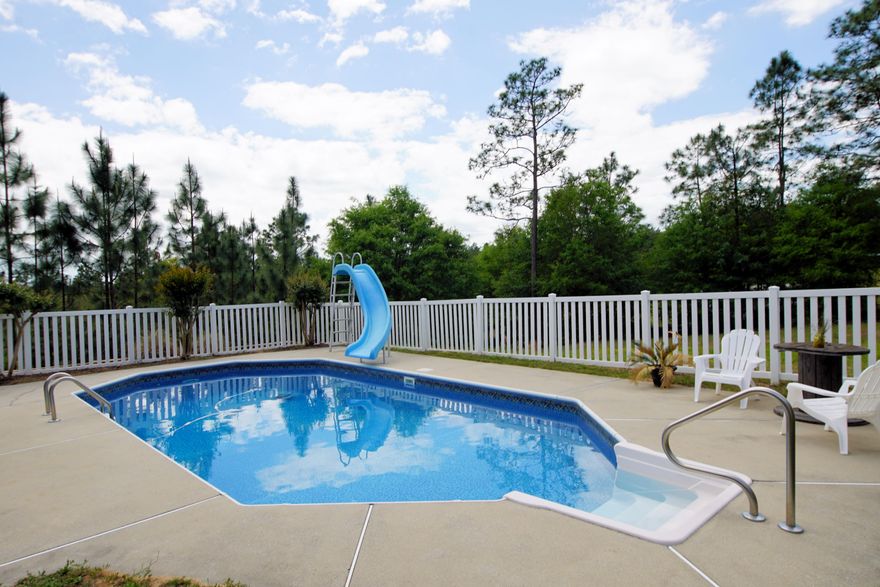 Welcome Home! Happy summers for the whole household with your in-ground pool that features a slide and large enough for any gathering. The cleverly designed open floor plan makes the most of the space, natural light and view of your back-yard paradise that feels private with no back neighbors.This home features 4 bedrooms and 3 full baths making it spacious and accommodating for any life style. It has plenty of room for everyone to come togetherIt has an eat in kitchen for those quick morning breakfasts and a separate formal dining room. You will actually enjoy whipping up gourmet meals in this bright, cheery and efficient kitchen. It features plenty of cabinets and counter tops highlighted with back splash.