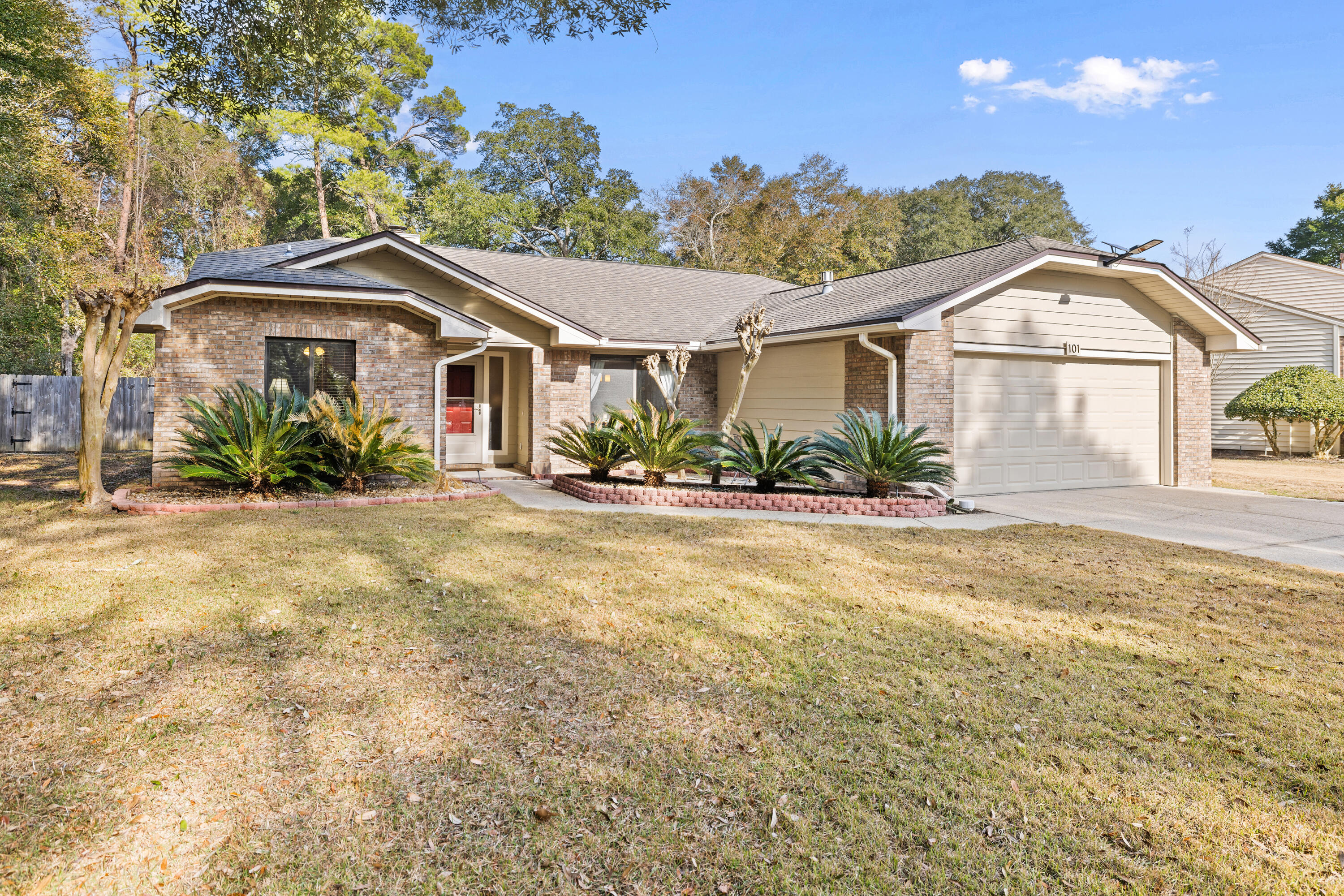 Let's paint a vivid picture of 101 Rockywood Way. Once upon a time, Barton Homes built this home with meticulous craftsmanship in the Rocky Bayou neighborhood of Niceville. This house isn't just any house - it is one that embodies quality construction, pride of ownership, and is situated on a quarter-acre corner lot. In the spring, a variety of lush Crepe Myrtles adorn the small private front open patio area. Inside, the house exudes a warm, welcoming atmosphere. From the foyer entrance, you enter the living room and enjoy the natural lighting from two skylights above, where the sunlight streams through, casting a golden glow on the laminate flooring. This cozy haven is where a crackling fire can be made in the wood-burning fireplace featuring a wooden mantel.     Click ''Read More' The front of the fireplace and hearth are beautifully accented with classic brickwork, adding texture and charm. What a way to invite long conversations and lazy weekends. The kitchen is situated so the chef can be included in the living room activities during meal prep time. It is outfitted with stainless steel appliances, oak cabinetry, and plenty of granite countertop prep space. The breakfast nook overlooks the spacious and wide-open backyard, which is large enough to add a pool without being encumbered by trees. The split bedroom plan is a sanctuary for comfort, each bedroom having frieze carpet, a 7' long closet, a ceiling fan, and 2-inch wood-colored faux blinds. The master suite, in particular, is a retreat within a retreat, featuring a spacious walk-in closet and an en-suite bathroom with a luxurious soaking tub and a separate shower that provides the perfect escape after a long day to soak or wash away the day's stress. Imagine stepping out the sliding glass doors to the open patio and unwinding by a fire pit with a glass of wine. Coming back to reality, the laundry room is very functional with cabinet storage and countertop space for a folding station. Store mops, brooms, and a vacuum in the handy utility closet. The pocket door allows you to close off the sound of the washer and dryer during cycles. In the garage, imagine a well-organized garage that makes any DIY enthusiast's heart race. Mounted on one wall, is a large peg board that keeps tools and small items within easy reach. Just below the peg board, there's a sturdy workbench made of solid wood. It provides ample space for any project. The surface is clean but shows the wear of many successful undertakings. Along another wall, top-mounted cabinets and built-in wood shelving units offer extra storage space. One of the top shelves stores the hurricane window coverings to include the skylight coverings. All in all, it's a practical and robust setup, perfect for working on projects, storing tools and supplies, and ensuring everything is secure and accessible. What kind of projects would you tackle in a garage like this? The dimensional shingled roof was replaced in 2016. All popcorn ceilings were removed in 2017. In 2024, all T-111 siding was replaced with Hardiboard and a fresh coat of paint. January 2025, the water heater was replaced with a 50 gallon gas-powered unit and a complete gas HVAC system was replaced with a new Trane R-410 refrigerant system. Easy access to schools, shopping, entertainment, Destin, and other local cultural attractions. Walking distance to "The Crossings" which includes Publix, Kovy Nail Spa, Crumbl Cookie, Walton Drycleaners, Fat Boys Restaurant, SuperCuts Hair Salon, and more. CEFCO gas station is on the corner and even 3rd Plant Brewery is within a short distance. What truly sets this house apart aside from its convenient location, is the palpable sense of pride that permeates every corner. Sellers have poured their hearts into maintaining and enhancing this home. Immense precision was taken in every repair, every upgrade knowing that their efforts would preserve the house's integrity. This is the magic that happens when a house truly becomes a home.