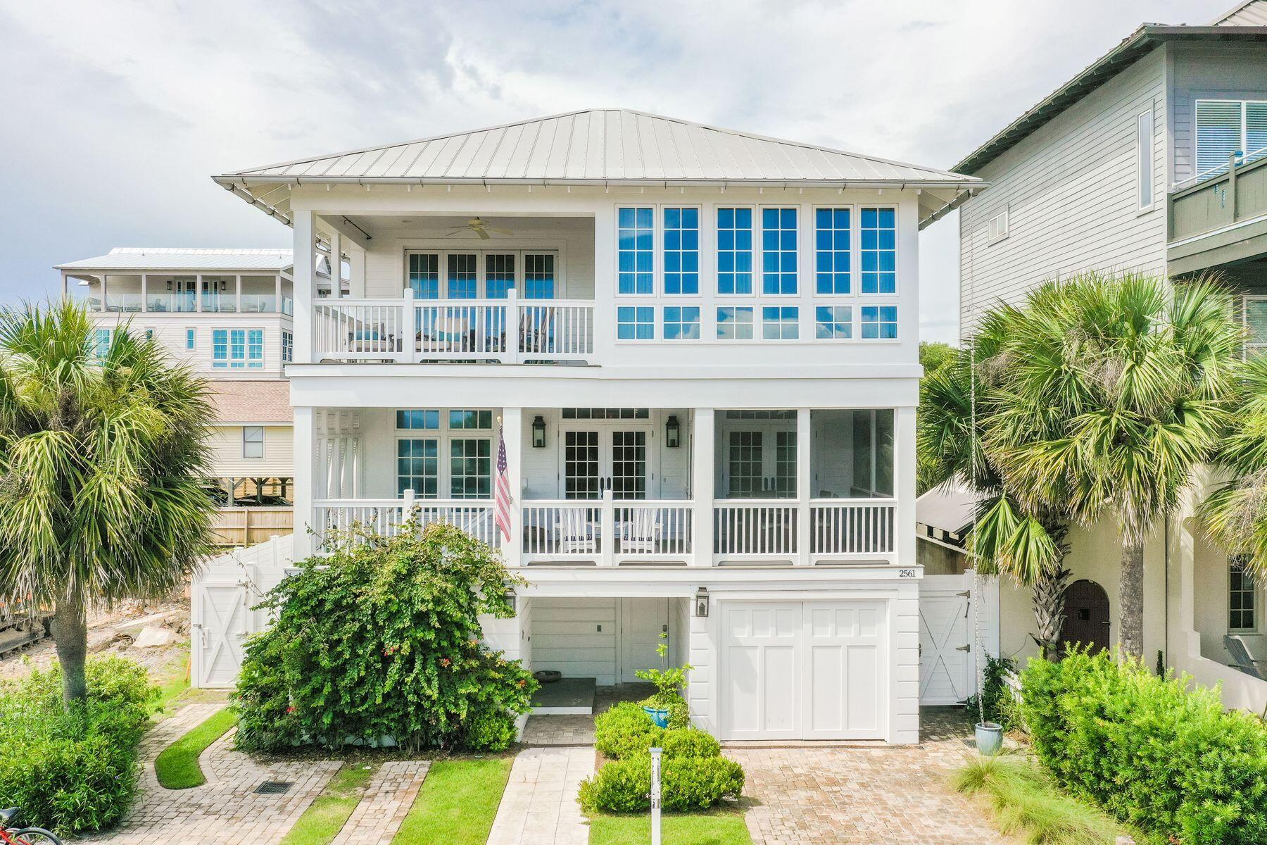 This magnificent beach home is one house from the beach with amazing views and an incredible outdoor living area with pool, spa, and lanai for the entertaining lifestyle. Steps from the white sandy beach, this prime located three-story home boasts breathtaking gulf views. This spectacular house was designed by renowned architect Sheldon Stone and interior designer Parker Kennedy in 2015. Four well-proportioned living spaces provide ample space for entertaining in style while guests can seek out their own quiet nook to relax or chat. White shiplap and soft nautical hues create a laid-back beachy ambience in a home designed for families and friends to come together and make memories. Floor-to-ceiling french windows bathe the main living area in natural light while gleaming hardwood floors