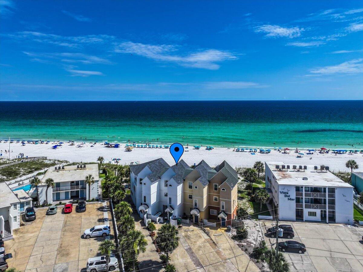 Why is this the ultimate coastal retreat? NO HOA! NO ASSESSMENTS! 2024 gross rental income of $131K with limited nights (196) offered for rental! Just think of the rental potential if offered 365 nights! This beachfront townhome offers direct beach access--yes, the stunning white sand beaches--Gulf views, making it the perfect blend of lifestyle and investment. This property comfortably sleeps up to 12 and features a versatile floor plan that includes a separate studio-style lock-out unit on the first floor, ideal for generating additional rental income or hosting guests with added privacy. Professionally updated, the home boasts a new roof with 50-year shingles to help with insurance costs, new LVP flooring, fresh paint, appliances, and two new A/C units with whole-home air purification system for year-round comfort. Offered fully furnished, this townhome is truly turnkey and has a proven track record as a successful STR. Guests will love the open living areas, beach-facing balconies, and the rare direct beach access - no roads to cross, just step out onto the sand.