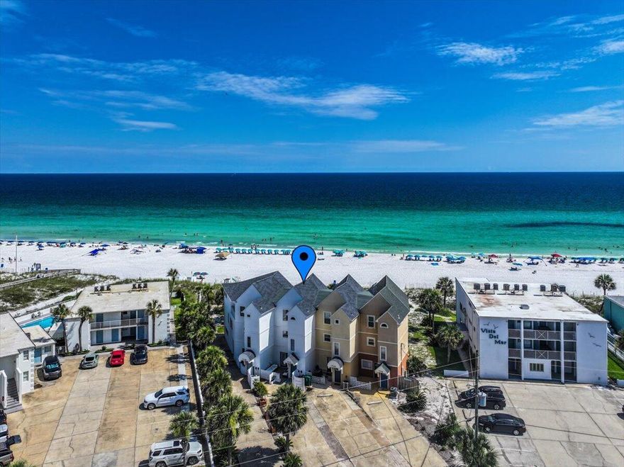 Why is this the ultimate coastal retreat? NO HOA! NO ASSESSMENTS! 2024 gross rental income of $131K with limited nights (196) offered for rental! Just think of the rental potential if offered 365 nights! This beachfront townhome offers direct beach access--yes, the stunning white sand beaches--Gulf views, making it the perfect blend of lifestyle and investment. This property comfortably sleeps up to 12 and features a versatile floor plan that includes a separate studio-style lock-out unit on the first floor, ideal for generating additional rental income or hosting guests with added privacy. Professionally updated, the home boasts a new roof with 50-year shingles to help with insurance costs, new LVP flooring, fresh paint, appliances, and two new A/C units with whole-home air purification system for year-round comfort. Offered fully furnished, this townhome is truly turnkey and has a proven track record as a successful STR. Guests will love the open living areas, beach-facing balconies, and the rare direct beach access - no roads to cross, just step out onto the sand.
