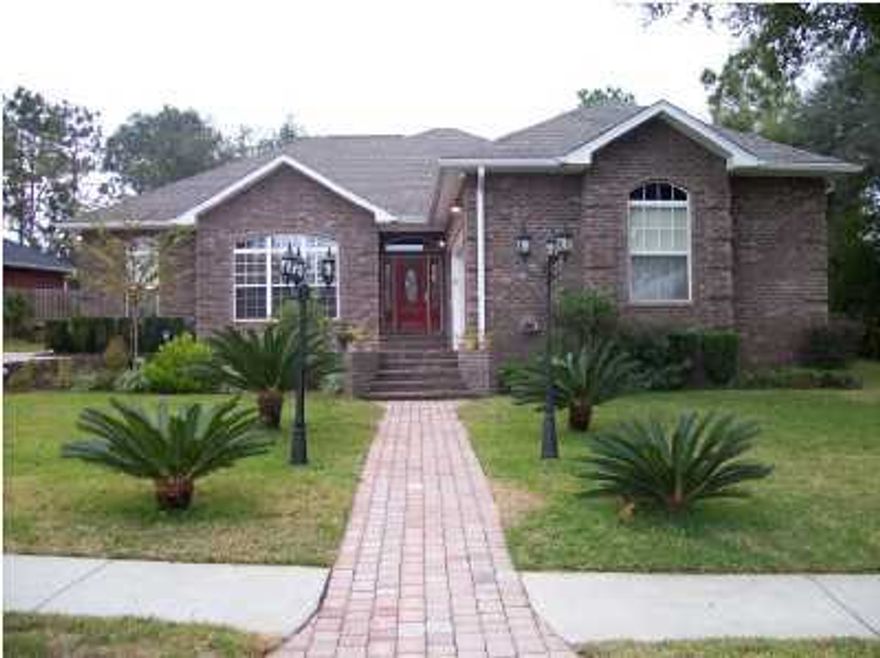 STUNNING HOME - from the moment you drive up the brick paved driveway with plenty of extra parking and walk thru the decorative doors - you will be impressed by this impeccable home. Large living area offers lots of room for family and friends. A computer/office space off the living area is an excellent feature. French doors from the living room opens onto a screened Florida room - perfect for outdoor enjoyment. The fabulous dine-in kitchen with rich mahogany custom cabinets, granite counters, breakfast bar, gas stove, stainless appliances, microwave, and a convection wall oven, truly a chef's delight! A beautiful formal dining room just steps away from the kitchen. This home offers a split floor plan with two guest bedrooms and guest bath on one side and the Master bedroom and bath