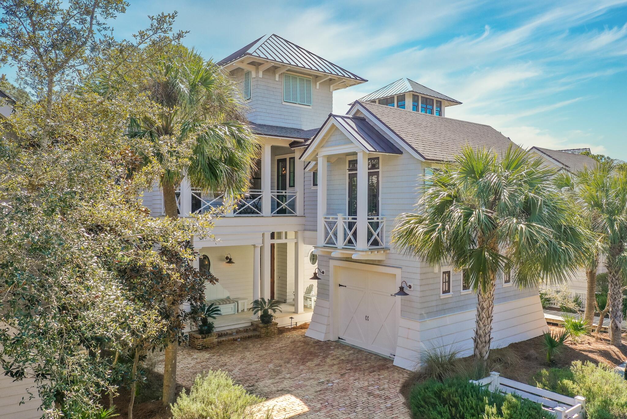 This stunning residence located in the Passages District takes full advantage of the surrounding topography and pristine Gulf views while showcasing the Nantucket inspired architecture found throughout Watersound Beach. Designed by architect Tom Chris and built by the renowned team at Velvet Sun Home Builders, the open floor plan features nearly 4,000 square feet of thoughtfully designed living space. Upon entering the front door you are greeted with a grand staircase adorned with shiplap accents. The living area boasts custom built-ins showcasing the brick accented fireplace. The chefs kitchen encompasses ample cabinet space, an oversized island with hammered copper farmhouse sink, and a professional grade appliance suite.