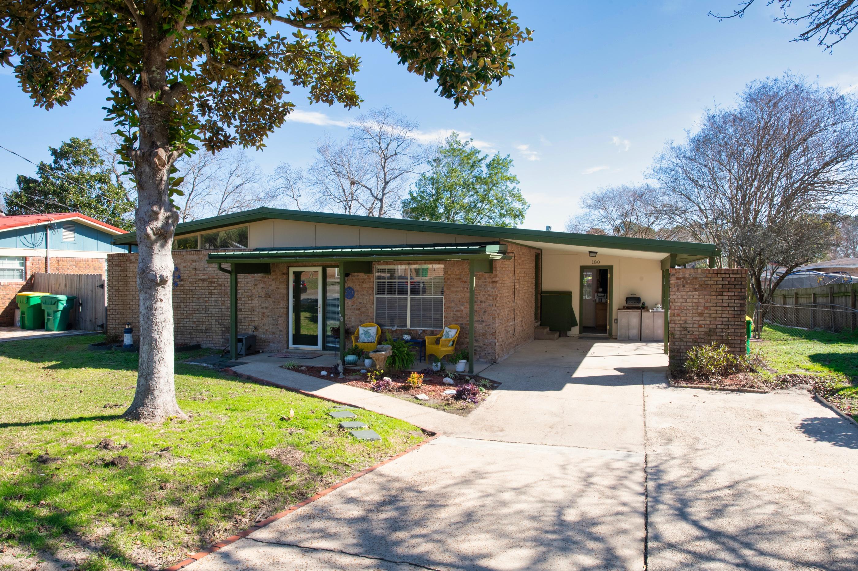 Mid-Century Modern Style - Brick Ranch! MOVE IN READY! Location, location! Quiet street with neighborhood sidewalks only 1 mile or less to schools, parks, shopping, etc. Only 3.6 miles to the BEACH, 4 miles to Hurlburt and 7 miles to Eglin. You'll appreciate all these updates: Long Lasting METAL roof (2016), new AC/Heat Pump AND duct work (2018), full electrical rewire (2014), exterior electric box replaced (2015), kitchen remodel w granite (2016), plumbing replaced/upgraded including hot water heater, bathrooms updated (2017), new doors (2020), new workshop anchored on slab in back (2018), new bedroom carpet (2021). This bright and open floor plan includes vaulted ceilings, tile floors, a living room and family room! Out back the large yard is fenced too! Home warranty included!