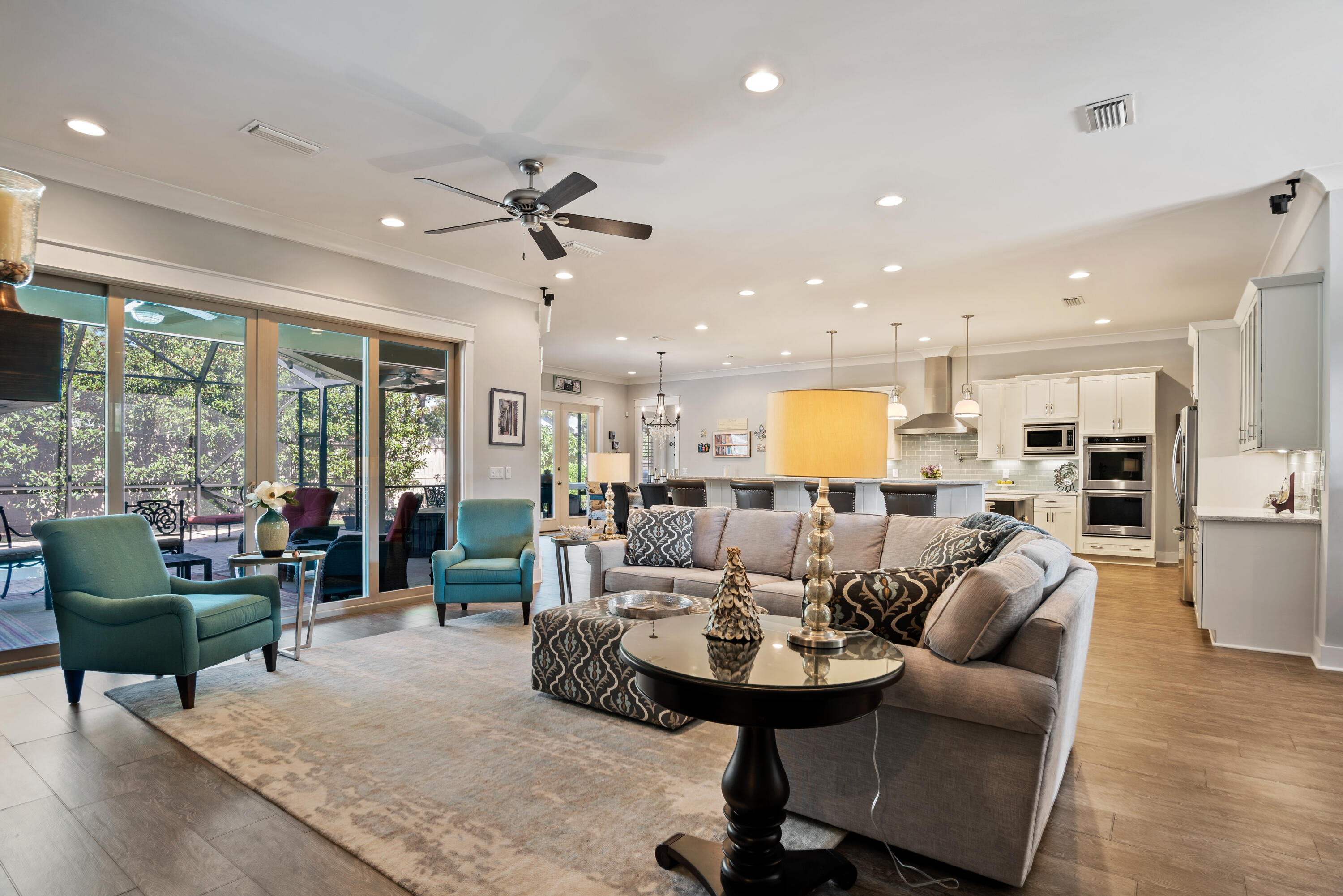 This stunner of a one-story brick home with 4820 square feet of covered area and 3134 square feet of heated and cooled area is less than a one mile from the front door to the beaches of 30A. Through the double mahogany front doors, you'll come into the oversized foyer to gaze out upon an open concept living area which includes the kitchen, dining & living space, and access to an office/4th bedroom. You'll be swept away by the porcelain tile, crown molding, and plantation shutters throughout this thoughtfully and beautifully designed floorplan. The gourmet kitchen with stainless steel appliances and a 5 burner natural gas stove with an oversize vent and pot filler. Preparing meals and entertaining is a breeze with the double oven, dishwasher, full size refrigerator/freezer recessed to counter depth. There are two large islands; one 44 sq ft counter level with double sink and the second with a two tiered with bar level for seating and dining. Every shelf and counter in the home is custom built wood. The kitchen counters are all Aria quartz and every cabinet and drawer throughout the entire home are all soft close. Open the separate pantry and find delight in over 75 square feet of space.
The south side of the home houses two large bedrooms including a second master with an en suite bath with granite countertops and large walk-in closet. The third bedroom has a double closet and a bathroom just next door. The bathroom has a single vanity with quartz counter and walk-in shower and is adjacent to a separate door leading out the lanai and pool area. Past the bedrooms is a large laundry room with extra cabinets, upper storage for bins and additional hanging area with upper shelf and an oversize utility sink with quartz countertops. Across from the laundry is a climatized storage closet with over 70 sq ft of storage.
Across the house and through the dining area large enough to accommodate a table with seating for at least 10 and with French doors allowing access to the lanai and pool. Look over into the living room where a natural gas fireplace and wooden mantle with floor to ceiling stone tilework, a television, and Bose surround sound will provide for the perfect ambiance. Double sliding doors open up to the lanai and pool. The pool is screened as an extension of the lanai and is heated with two benches, one is a larger jetted spa area and features remote control operation, including lighting. Both the lanai and front porch have textured concrete finishes.
The master bedroom is a perfect oasis encompassing the entire north side of the home. The sleeping area is large enough for a king bed and a sitting area and features two large walk-in closets. The master bath has separate vanities, a large linen and storage closet & a separate water closet. The master shower provides for an extra wide entry/drying area that allows for handicap access and a bench with a separate hand-held fixture. The bathroom has a garden soak tub in one corner.
In addition to all of the features above, this phenomenal home comes with hurricane protection with Fabric Shield covering for all doors and windows PLUS a whole house Generac generator and a Rinnai tankless water heater. The home has a gated and fenced-in area to the rear. There is a 14'x30' concrete pad inside the gate to park an RV or boat and an adjacent 7'x11' storage building.