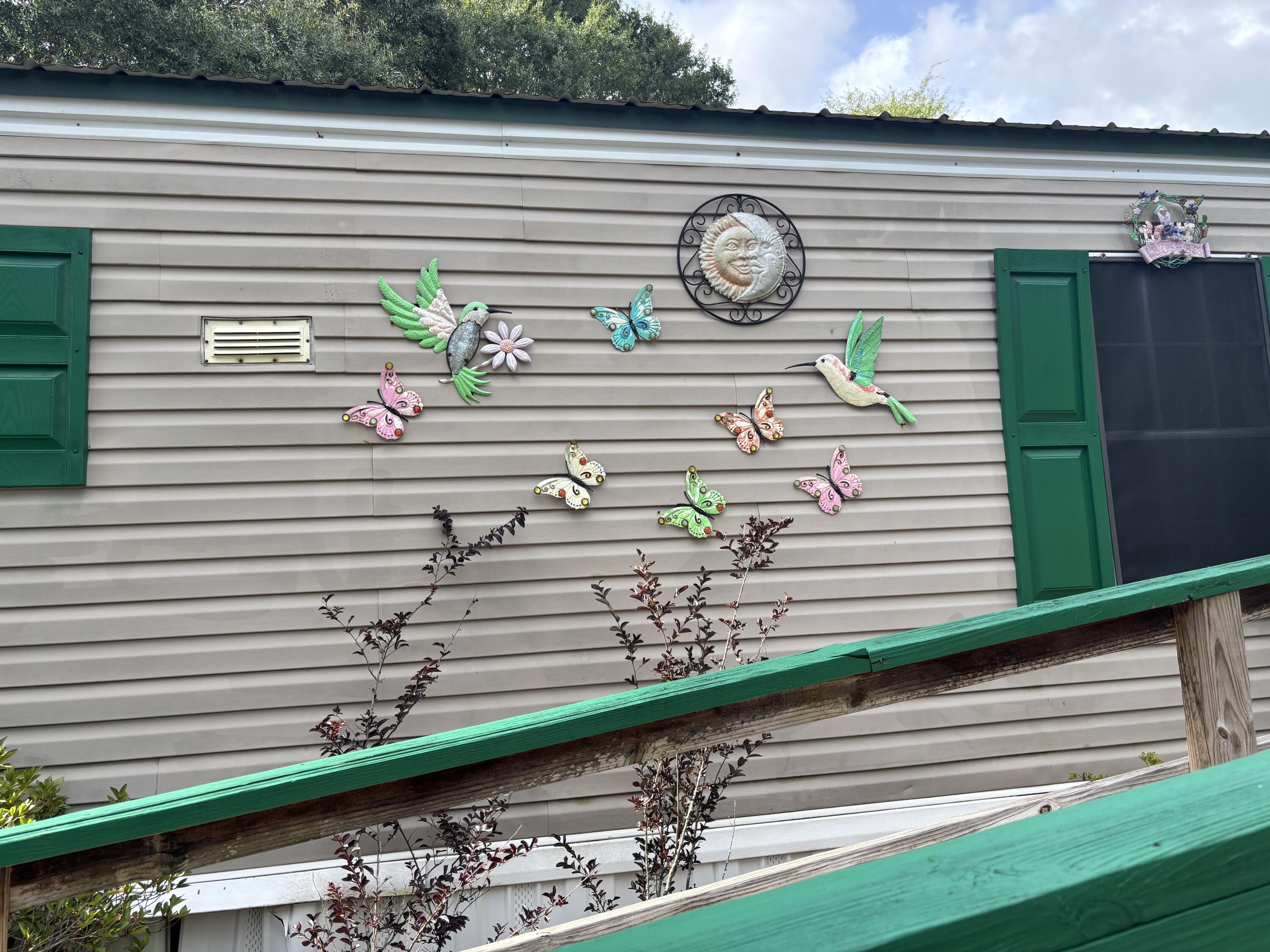 Welcome to this charming manufactured home situated on 2 spacious lots, totaling nearly 1/2 an acre. Enjoy peaceful mornings on the front porch or back deck, ideal for sipping coffee and taking in the surrounding nature. With a 16x16 building with metal roof can serve as a workshop or hobby space.The fully fenced yard offers privacy and flexibility whether you're considering adding a pool or creating a garden retreat. Large Concrete pad could be an RV spotInside, the home offers an excellent opportunity for customization. With a little TLC, this property has strong potential for use as a primary residence, seasonal getaway, or an addition to an investment portfolioConveniently located only approx. 50 min. To the beautiful South Walton Beaches, 20min to downtown Defuniak.