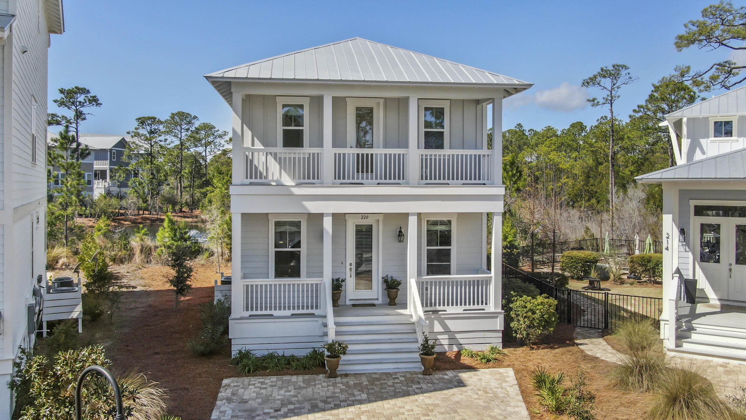 Walk to the Beach in 10 Minutes from this Pristine 3 Bedrooms, 2.5 Bath Beach house. This home is Move in Ready, has never been rented and is offered fully furnished. The home Features gorgeous hardwood floors, an abundant amount of Natural Light, Granite counter-tops and Vanities, Open Floor Plan, tile Backsplash, Quality Stainless Appliances, Gas Range, Tankless Water Heater, Separate Built-in oven and Microwave, A Huge Master Bedroom with a splendid deck and a generous Master Bath with a lovely Walk-in tile Shower and Plenty of Closet and Storage Space. Outside there are 3 Covered Porches one screened-in for Enjoying the outdoors, Decorative Paver Walk-Ways Sitting Area and Parking area. An automated irrigation system makes maintenance a breeze.