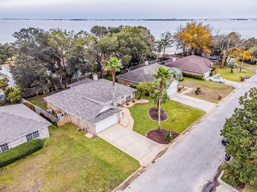 Welcome to your beautiful and updated waterfront community home here in the Emerald Coast! Features 4 bedrooms and 2 bathrooms. This home is move in ready and ready for its new owner! Featuring 2018 roof, newer HVAC, fresh paint, updated landscaping, and BRAND NEW carpet to be installed to bedrooms. You will only be steps away from the Sandy Beach community area featuring a new pier and covered picnic area. Enjoy countless sunsets here in paradise!