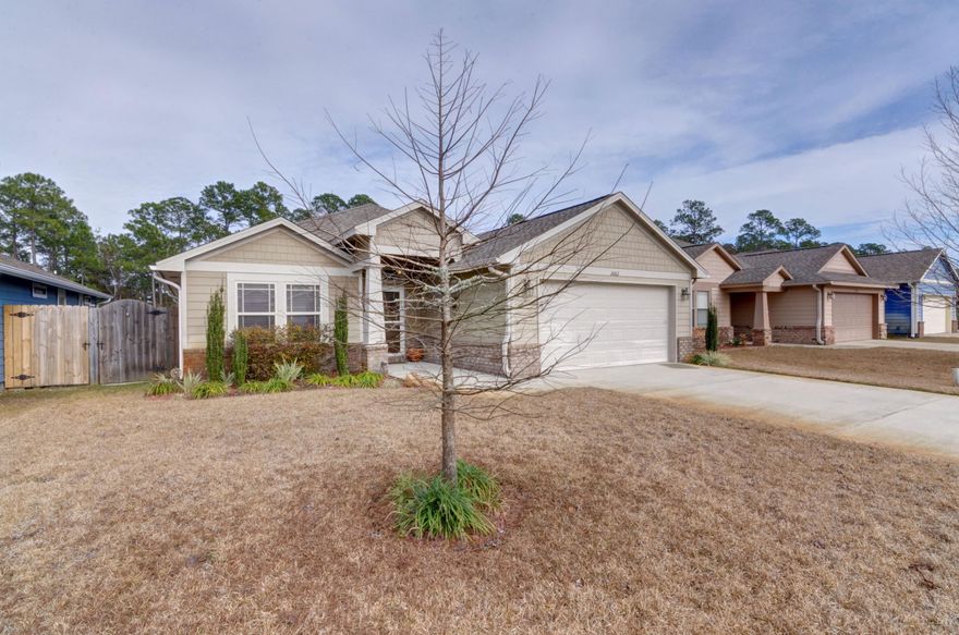 Simply Said....Welcome Home ~ This Craftsman Style dream home is like new ~Exquisite inside & out and offers an ideal location in The Cottages of East River, a newer, no through road, sub-division surrounded by Greenbelt ~just minutes from the beach and short drive to Hulburt Field AFB.This 3 bed/2 bath home is fully fenced with a huge back yard~Home offers great curb appeal, covered front porch with brick accents and craftsman columns. Entering the home, you will appreciate the Gorgeous wood plank tile that flows through the family room with high ceilings, crown molding and open flow to the large dining area with trey ceiling, crown molding & huge hop up breakfast bar ~ Gorgeous kitchen with lots of cabinet space ~ granite counter tops, tile backsplash, stainless steel appliances, , under mount sink & pantry. Separate utility room which opens to the finished garage with pull down stairs and remote garage door. Master bedroom with trey ceiling and center fan, Master bath has double vanity, large step in tub/shower and separate WC. Additional bedrooms are a good size with large double closets & ceiling fans, additional bathroom with tub/shower and Granite vanity. Double doors from the dining area offer access out to the back garden and covered back extended porch with sweeping pathway around to the side gate. Back garden is a great size and backs on to greenbelt for privacy ~offers a gazebo, garden swing and built in stone fire pit ..everything you could want to enjoy those Wonderful Florida evenings. Home is beautifully decorated throughout with soft grey tone colors and a great feeling of space in every room. Additional features of this home offer a transferable termite bond, custom window blinds~gutters~storm door~New sod in the front yard with lawn pump and sprinkler system for easy care in the summer months, East Navarre location close to the beach, base and local stores...call today to make an appointment to view this wonderful move in ready home.
