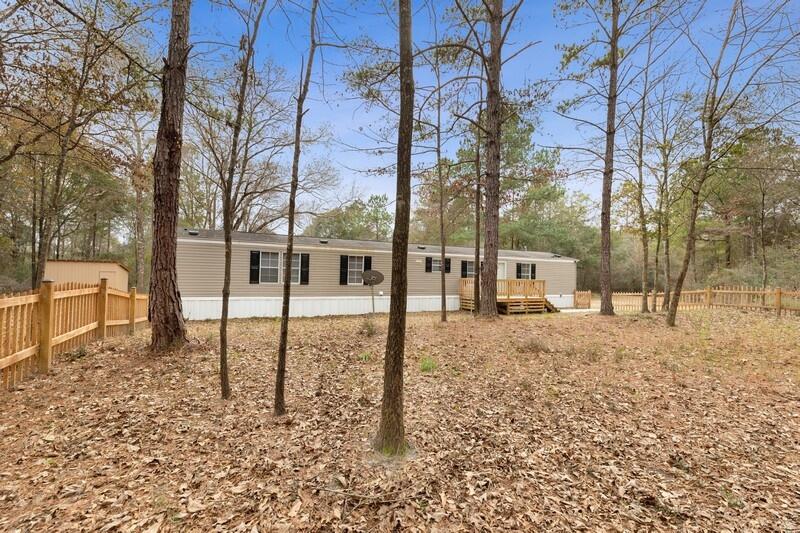 5 beautiful acres with a newer well kept home in North Crestview! 3 bedrooms, 2 baths, plus flex space and separate laundry room. Relax on your front deck enjoying the peace and privacy around you. New vinyl plank flooring in living room, kitchen, bathrooms and laundry/flex space. Dishwasher replaced 2022, stove/oven replaced 2020. Large fenced-in area for pets off the front door, 1 tool shed, 1 larger walk in shed, and an even larger shop will convey! Walking trails and blueberry bushes throughout the property for you to explore- you don't want to miss it!