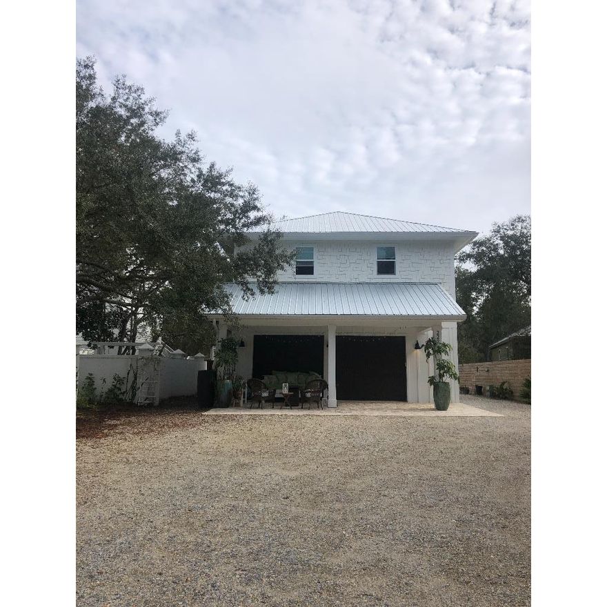 Located off of 30A, nestled by Camp Creek Lake on a quiet dead end street, this property is a 7 minute walk to the beach and conveniently located between Rosemary Beach and Seaside.  The 784' Carriage House (Apartment above the 2-car garage) was completed in 2019 and sits in the front of a long double lot. In the rear of the lot, there is an adorable little 800' cottage that is perfect as a guest cottage or a multi-generational home. The Cottage was renovated with an addition added in August 2019. In the center of the property there is an opportunity to build a main house that would provide lake and ocean views and Sunsets over the water. In the current owner's plans, there is room for a pool behind the main house.