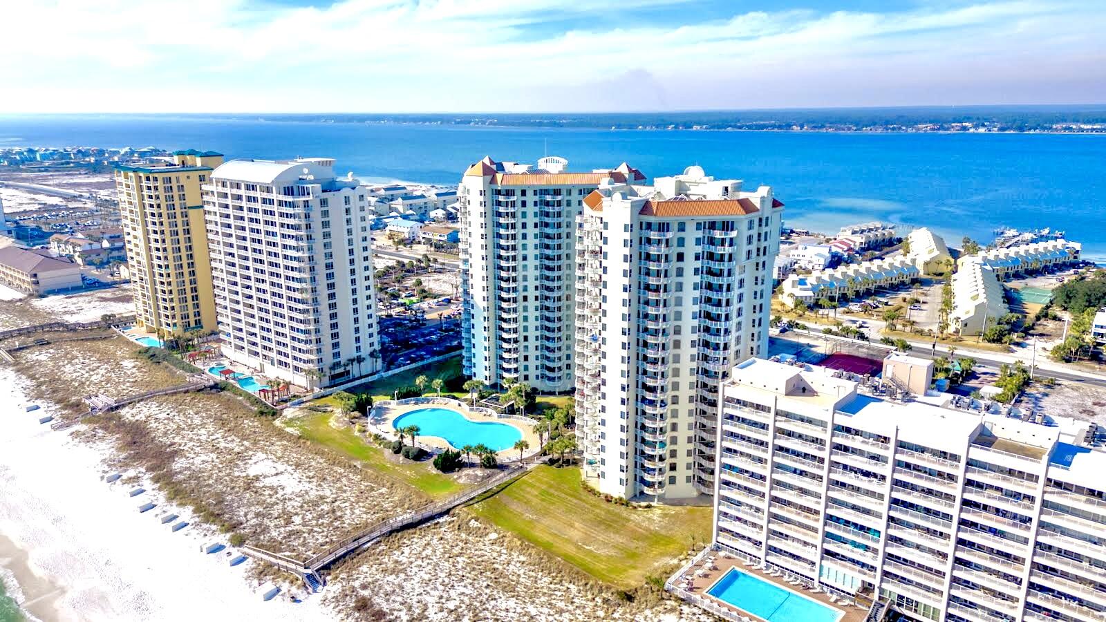 Gated Entry and eastern-facing, *Direct Gulf Front* unit is Turn Key Furnished with Updated Coastal Decor, New Benjamin Moore Paint, LVP Flooring, New Stainless Appliances, Trane HVAC, and EXCELLENT NET Rental Income in 2023. Immersive blue-green Water Views of the Gulf of Mexico and Santa Rosa Sound are captivating and featured in Every Room. Open-concept living, dining, and kitchen offer unobstructed views with a warm and charming Neutral Coastal vibe thanks to updated Decor, lighting, and newly painted interior. Massive covered Gulf Front Balcony is accessible both from Living Space and Primary Suite. Primary Suite features walk-in closet, dual vanities, separate tile shower and soaking jet tub. Both the King Ensuite and the Double Queen guest rooms feature Water View Balconies.