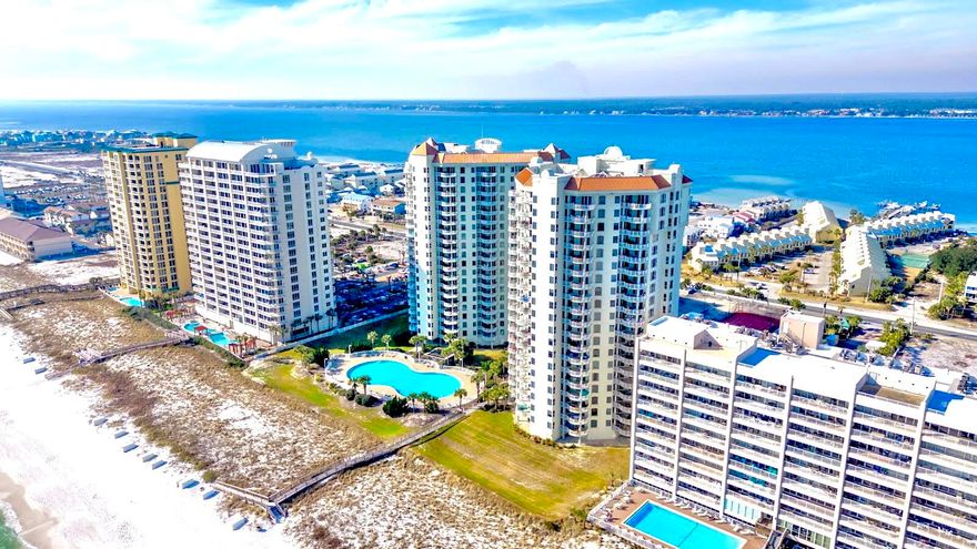 Gated Entry and eastern-facing, *Direct Gulf Front* unit is Turn Key Furnished with Updated Coastal Decor, New Benjamin Moore Paint, LVP Flooring, New Stainless Appliances, Trane HVAC, and EXCELLENT NET Rental Income in 2023.  Immersive blue-green Water Views of the Gulf of Mexico and Santa Rosa Sound are captivating and featured in Every Room.  Open-concept living, dining, and kitchen offer unobstructed views with a warm and charming Neutral Coastal vibe thanks to updated Decor, lighting, and newly painted interior.  Massive covered Gulf Front Balcony is accessible both from Living Space and Primary Suite.  Primary Suite features walk-in closet, dual vanities, separate tile shower and soaking jet tub.  Both the King Ensuite and the Double Queen guest rooms feature Water View Balconies.