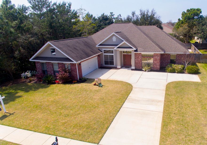 WELCOME HOME to Florida living at its best....This beautiful custom built 4 bed 3 bath home is located in the Prestigious Water Front lifestyle of Heritage Park .A private GATED community located on the Santa Rosa Sound.Homeowners enjoy vintage light cobbled entry, curbed sidewalks, ornate mailboxes, underground utilities and a WATERFRONT clubhouse featuring an in ground pool...designed to enjoy the best panoramic views over the Santa Rosa Sound, workout room, conference area, lounge with TV and a fully fitted kitchen ...all with breathtaking views of the Island from its elevated location~ Homeowners can also enjoy the common green area with deeded access to the beach and Sound....Perfect to walk and watch the beautiful sunsets or just sit on the seawall and feel that wonderful Gulf breeze Your 2676 sq. ft. home is ideally located within the community and boasts landscaped front garden with manicured borders & new Zoysia grass~ Kickback in your peaceful fully fenced back yard with large covered porch to cook out and soak up those wonderful Florida evenings. This custom built home greets you with a columned porch ~tiled foyer with open flow through to the family room with wood plank tile flooring, crown molding ~ focal point fireplace and gorgeous custom built shelving and entertainment area~also wired for surround sound....Your spacious gourmet kitchen features glazed cabinets, Corian countertops, center island , pantry, black  appliances with built in microwave and convection oven,stove top and overhead extractor .Hop up bar that wraps around to the family room & large breakfast area for your "on the go days".  Home also enjoys a formal dining area with grand columns, high ceilings, and soaring windows that have solar film tinting.Master bedroom suite with trey ceiling & crown molding is large enough to accommodate a sitting area for your enjoyment. Luxurious master bathroom with Jacuzzi tub ~ separate corner Cultured Marble shower .Master suite bathroom has plenty of dressing area, walk in closet ~ Cultured Marble double vanity with separate WC . This split floor plan home has oversized additional bedrooms with huge double closets /2 bedrooms share their own private bathroom with separate entrance from one of the bedrooms offering two vanities and closed off shower /tub. The 3rd additional bedroom enjoys its own bathroom which would make for a great teenage room or guest area & also has access to the back porch and garden. You will appreciate the attention to detail throughout this custom-built home with high ceilings, deep base boards, crown molding, bull nose corners, recessed LED lights. Huge separate close off laundry /mud room with storage cabinets ~ oversized garage offers additional storage space, courtyard entry and extended driveway/ timed irrigation system are to name a few of the additional features you will enjoy. Home was recently fitted with metal hurricane shutters ~NEW A/C installed in 2017 & Water Heater in 2015.???????Heritage Park is located on the East side of Navarre...ideal for the local shops and in easy access of the Navarre Beach Bridge across to the beautiful white sandy beaches of the Gulf of Mexico. Relocating to Hurlburt Field ..no problem you are in 10 minutes drive from the front gates ..Drone pictures attached to experience the true value of this location... sit back and relax .....You've just found your new home. 

