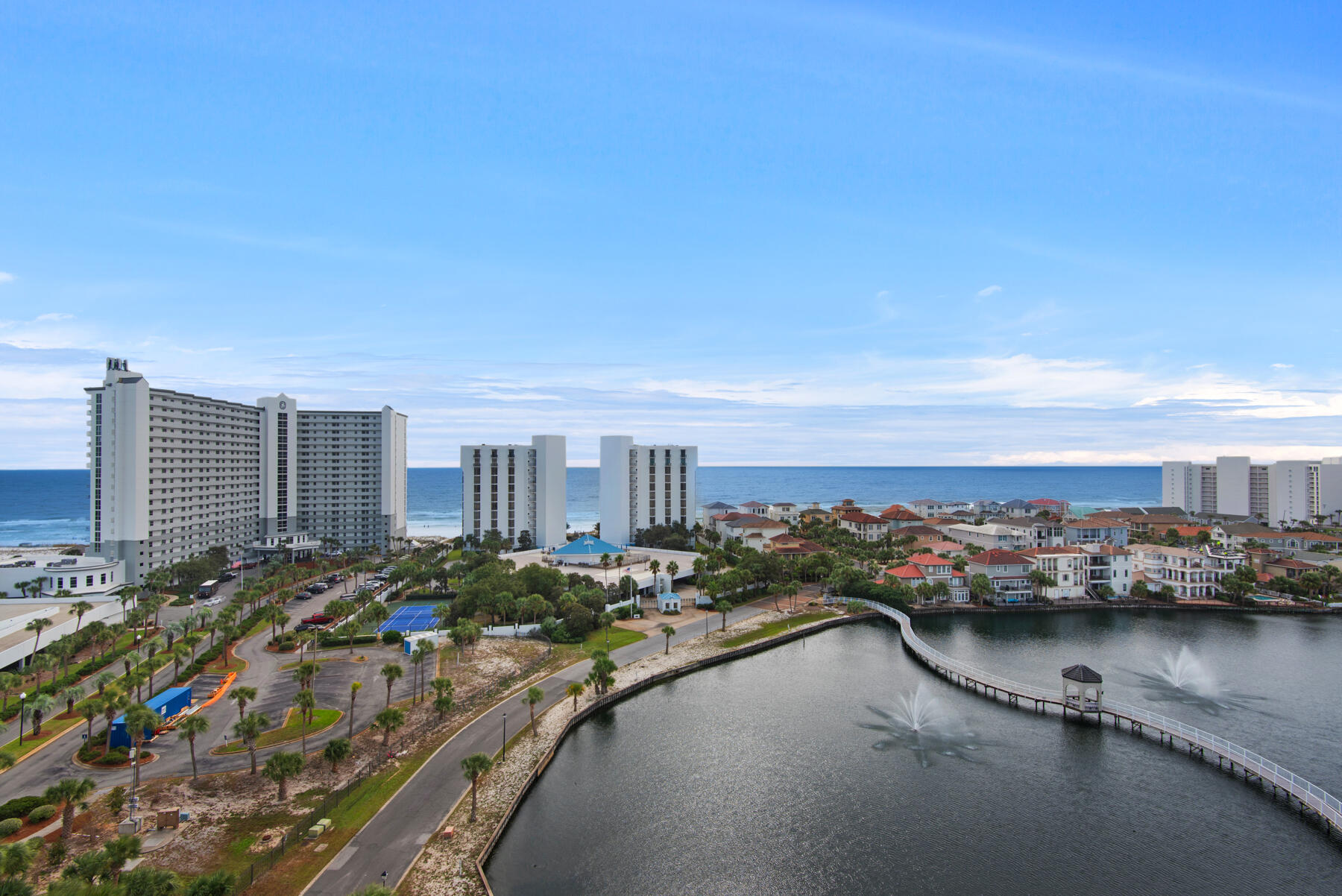 Discover the epitome of luxury in the stunning 11th floor upgraded corner 3 bedroom 3 bath unit with wrap around balcony, offering breathtaking, panoramic views of Destin, the gulf, and coastal lakes. Enjoy front-row seats to stunning sunsets and dazzling weekly seasonal firework displays. This rare gem also includes a deeded covered parking space. Perfectly positioned in the heart of Destin, you are mere steps away from the vibrant Destin Harbor. This exceptional unit showcases numerous upgrades, including elegant luxury vinyl tile flooring throughout, sleek quartz countertops, smooth ceilings, and custom designer furnishings. The bathrooms have been remodeled with premium Bath Fitter installations. The open-concept kitchen with new stainless appliances, dining, and living areas create an expansive setting ideal for family gatheringand upscale entertaining. Effortlessly transition between indoor and outdoor living as sliding glass doors connect the living room and master suite to the balcony, offering unparalleled views. The third bedroom provides additional privacy and versatility, featuring a kitchenette with a microwave, refrigerator, sink, a private balcony, and a full bath. Convenience is further highlighted with a stackable washer and dryer, a pantry, and an owner's closet for extra storage. Located within one of the Emerald Coast's most sought-after vacation complexes, this guard-gated resort boasts an impressive array of amenities. Beyond the numerous on-site features, owners and guests also enjoy exclusive access to the facilities at Pelican Beach Resort, enhancing their recreational and leisure options. Bask in a sun-soaked beach day on the private beach, meticulously maintained by Pelican Beach Resort, just a 5-minute walk along a scenic boardwalk from The Terrace. Stay active on the tennis courts or in the well-equipped gym, unwind at the Tiki Bar, or rejuvenate in the hot tub or steam room. Cool off in one of several pools, including the stunning 114-foot zero-entry pool. Find tranquility in the sauna or spark some fun in the game room. For even more excitement, Big Kahuna's Water Park is conveniently located just across the street, while Destin's finest attractions, shopping, dining, and vibrant nightlife are mere moments away. Perfect as a primary residence, second home, or a lucrative vacation rental, this turnkey unit, with its thoughtful upgrades, is ready for your next luxurious chapter.