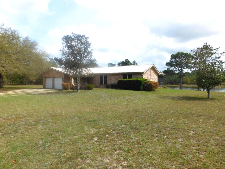 Waterfront with over 3 acre lot.   All brick home with 3 bedrooms, 2 baths with 3.10 lot and 291.80 ft waterfront.  Split floor plan with hardwood floors.   New kitchen flooring.  Metal roof and air conditioner replaced within 5 years.  Large screened in porch with lovely water view.  Two car garage with side entry door.  Seller to provide Home Warranty for buyers peace of mind.  Take a look and make this hard to find property yours today!!