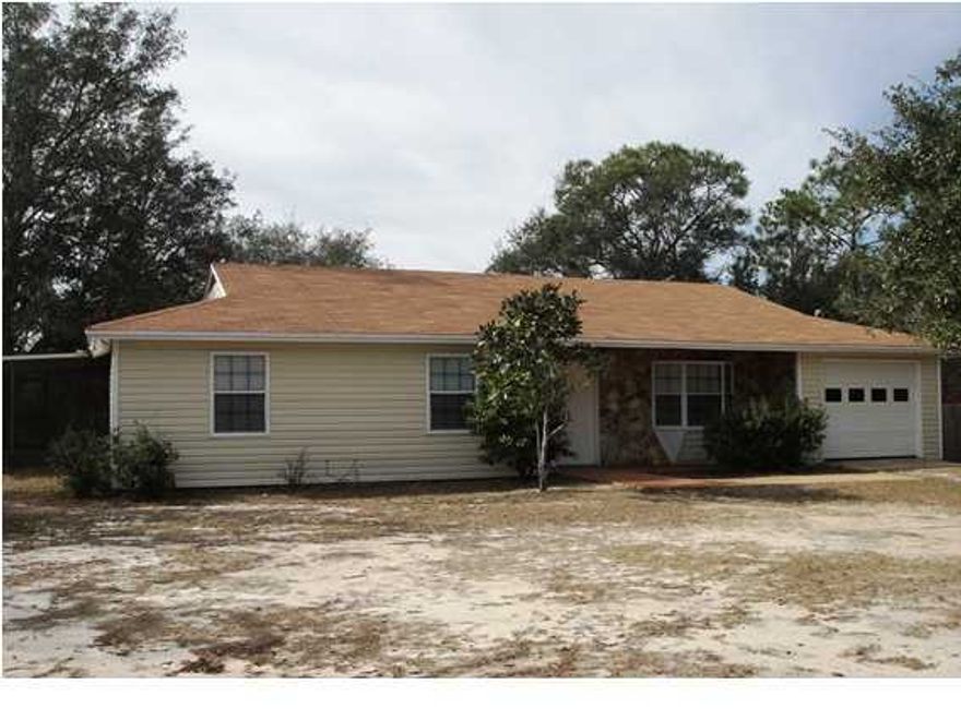 This lovely 3BR/2BA country home is located on a large corner lot in Navarre, Florida. This rental home offers an open floor plan with a stone fireplace in the living room, oak cabinets in the kitchen, a separate dining room, and a screened patio off of the master bedroom.There is also a large fenced backyard for outdoor activities.Pets are not permitted at this home. This property will be available for rent in January, please call for showing instructions.