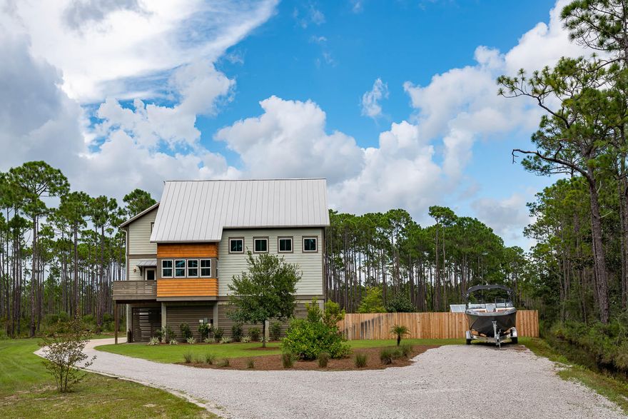 This chic, modern farmhouse located  on TEN acres is designed by famed architect David Sargent. The home was designed with large open spaces, high ceilings and wide gallery halls, mixing modern with complete comfort. This four bedroom, four bath private sanctuary offers two living areas and office space. Interior features include a stunning chefs kitchen, custom cabinets and stainless steel appliances, covered parking for seven, plus one golf cart, well, sprinkler system, Schwinco Impact Turtle glass windows, two AC systems, integrated house de/humdifier, built in vac system, gas stove and BBQ, all spray foam insulation, hardwood throughout, all LED bulbs, ethernet and built in surround sound Bose speakers. Complete charm with two sets of antique gates from the 1400's and 1800's that leads you into the quaintly landscaped patio. The property allows for horses, 30amp RV power hook up and is close to the Charles E Cessna Landing Park with bay access. Property has been split with second five acres a buildable site for investment opportunity. (PLEASE note that approx 80% of land is CONSERVATION USE). Buyer to verify all dimensions and buildable area.