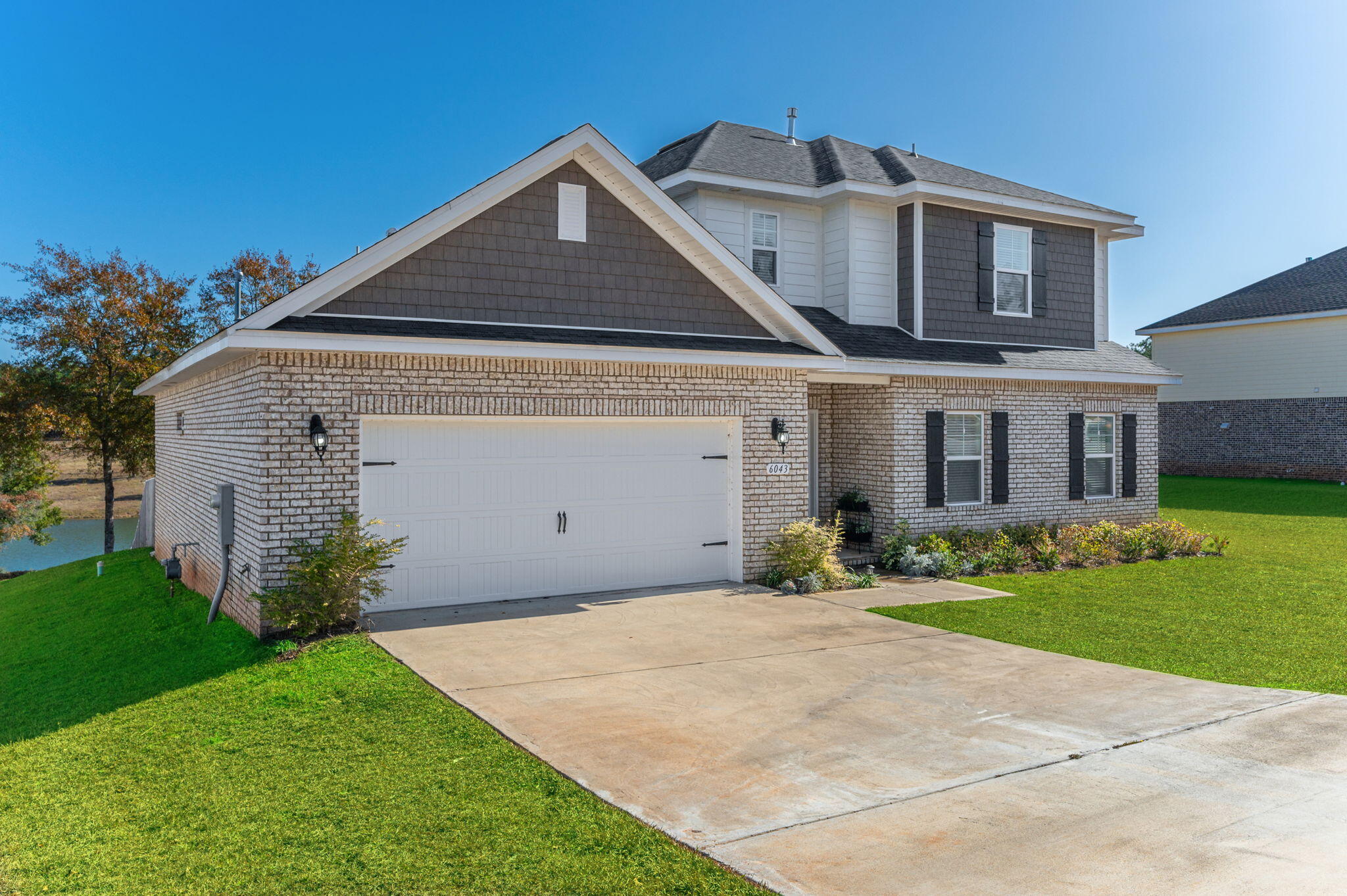 This beautifully designed 4-bedroom, 3-bathroom home located in North Crestview in Nature Lake subdivison offers the perfect blend of comfort and functionality. Stepping into the home you will be greeted with an abundance of nature light in a spacious open concept layout. The kitchen has granite countertops with a large island with plenty of room for chairs. The first level features a generously sized primary bedroom with views of lake, 2 large walk-in closets, zero entry tiled walk-in shower, and double vanities. Upstairs are the additional bedrooms with a full bathroom. Step outside to a covered rear lanai with scenic views of the lake. Don't wait, tour this home today!