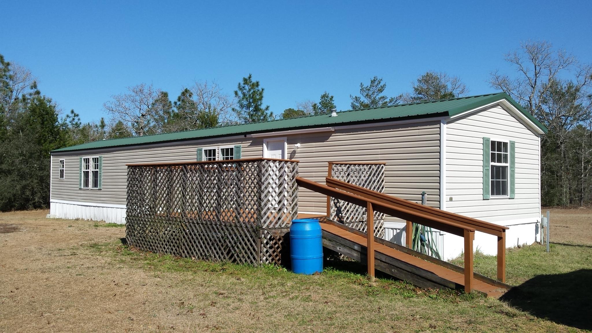 OWNER FINANCING AVAILABLE!!! Ready to move to peace & quiet? This has a Crestview address but is really located in Mossy Head, FL. This secluded acreage boasts a 2004 Mobile home with 2 beds/2 Baths that is renovated with NEW CARPET, NEW PAINT, NEW DOORS, NEW SINK, and much more. The Land is partially cleared with a deep well. Get ready to build your dream home! Parcel located next to Blackstone Golf Course, the new FedEX distribution center, and minutes to the Interstate to take you to the beautiful white sandy beaches & Emerald green waters of the Emerald Coast!