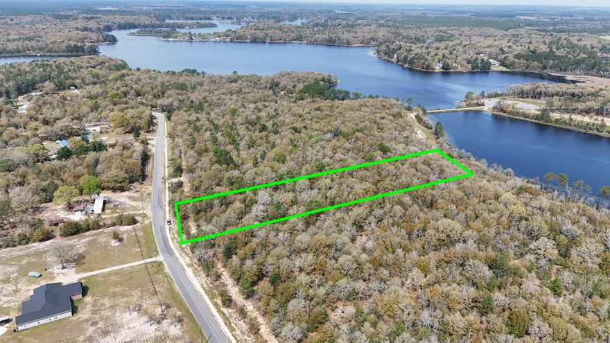 Introducing Lot 7 in Seacoast Estates--a 2.49-acre waterfront homesite tucked away on a quiet, paved road with access from Martin Road. This rare, high-and-dry property offers ample space and privacy to build your custom dream home, vacation retreat, or income-producing short-term rental. Enjoy peaceful surroundings and direct water frontage on Holly Lake, one of Northwest Florida's most desirable freshwater lakes known for its excellent fishing and recreation. The low-HOA community of Seacoast Estates features planned walking trails, a community dock, and a boat launch on Seacoast Lake. As a property owner, you'll also be permitted to build your own private dock on Holly Lake, giving you effortless access to the 250+/- acre lake right from your backyard. With boat launch access to the 50+/- acre Seacoast Lake, this is truly a water enthusiast's paradise. Short-term rentals are allowed, making this a smart investment with strong vacation rental potential. Plus, the neighborhood allows detached garages, sheds, and barndominiums, offering flexible options for how you develop the land. Located just 45 minutes to the white-sand beaches of the Gulf and only a short drive to town for shopping, dining, and essentials, Lot 7 delivers the ideal blend of space, privacy, and accessibilityall in a serene, waterfront setting.

Lot lines are approximate; buyer to verify all information deemed important.

