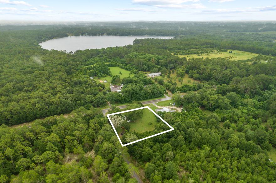 Don't miss this opportunity to build your dream home on this nearly 1 acre fenced lot featuring mature landscaping, beautiful shade trees, electric, two septic tanks, well water, public water, and paved road.  There is a small home on the property that could be your next project. 
Only 5 miles from downtown Defuniak Springs and approximately 30 miles to the beaches of South Walton.