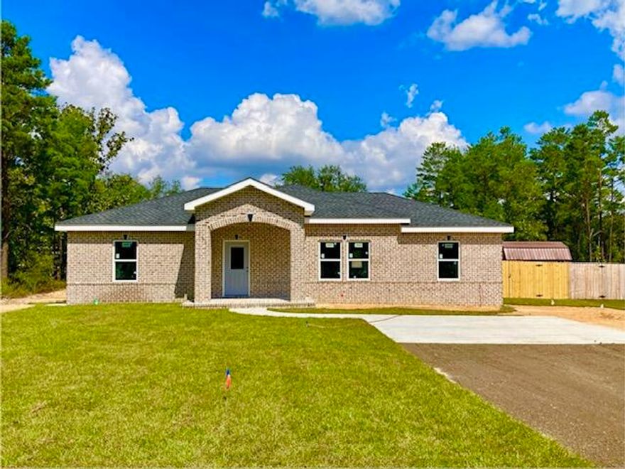 A CUT ABOVE! 3BR 2BA ALL BRICK HOME This house has many custom upgrades at spec home pricing! Quartz countertops & tankless gas water heater for continuous hot water. Lovely ceramic tile flooring, stainless appliances (including refrigerator), all wood Shaker style cabinets, crown molding and 9-foot ceilings in main living area will delight any new home buyer. Kitchen & bath faucets are brushed nickel and tall toilets are upgraded ADA compliant. All int & ext walls are insulated for soundproofing. The entire attic has spray foam insulation. Back yard has a 6' PT privacy fence, and the10x18 concrete patio is stubbed for your gas grill hooked up to the 120 gal propane tank. Oversize front concrete parking pad & asphalt drive. 1-year Builder Warranty. This brand new home is a must see!