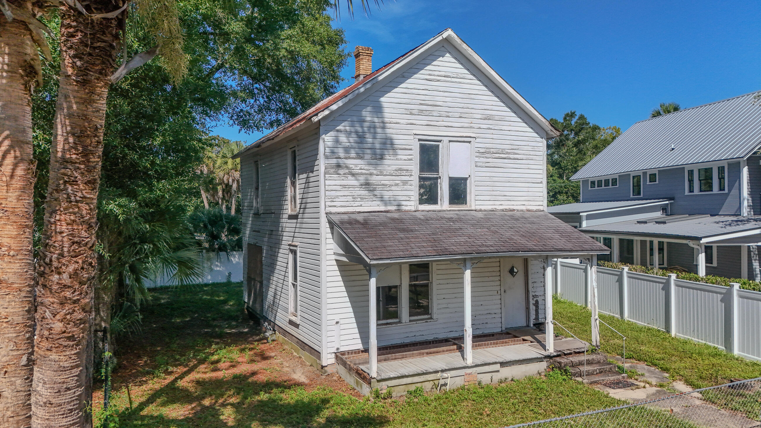 Watch the sunrise over Lake DeFuniak and a clear view of the iconic Chautauqua Hall of Brotherhood. This historic district gem is a rare find and has been professionally leveled, gutted, and rewired and new vinyl privacy fencing - a solid foundation for your restoration vision. Includes the kind of details preservationists love like T&G pine, fabulous hardwood floors, period staircase and original wavy glass windows that remind you why old homes are worth saving. This is old-school craftsmanship at its finest, with the ability to add on as well. The lot is small and low-maintenance, perfect for those who want charm without the upkeep. Walk or bike to the library, downtown, and everything that makes DeFuniak Springs shine. With soul, personality and possibilities, this one's worth a look.