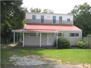Commercial building with frontage on Hwy 90 and on Hudson St for easy ingress and egress. Sale includes 2 tax id numbers. The property is located just outside the city limits of Crestview. Building is 2 story, with 3 office spaces, 2 bathrooms and a foyer area on the bottom floor. The top floor has a full bath and kitchen, so could be lived in while you run your business downstairs. Great set up for the entrepreneur! The lot is large enough for possible expansion. County plat map shows an alley between the 2 properties, but owner says that it has been vacated by the county. Potential buyers should verify all information. This large lot lies adjacent to the city limits.
