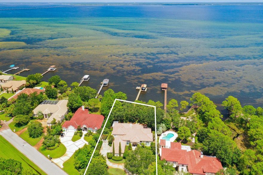 The epitome of waterfront living perfectly poised on a private estate sized lot (.88 acre) yielding an impressive 115' of premium water frontage on the Choctawhatchee Bay. This beautiful four bedroom retreat has been meticulously maintained with notable features including ample privacy created by lush mature landscaping, new hardwood flooring throughout the first floor, fresh interior and exterior paint, first level master suite and an expansive 45x25 private bay-front pool presiding over endless water views.