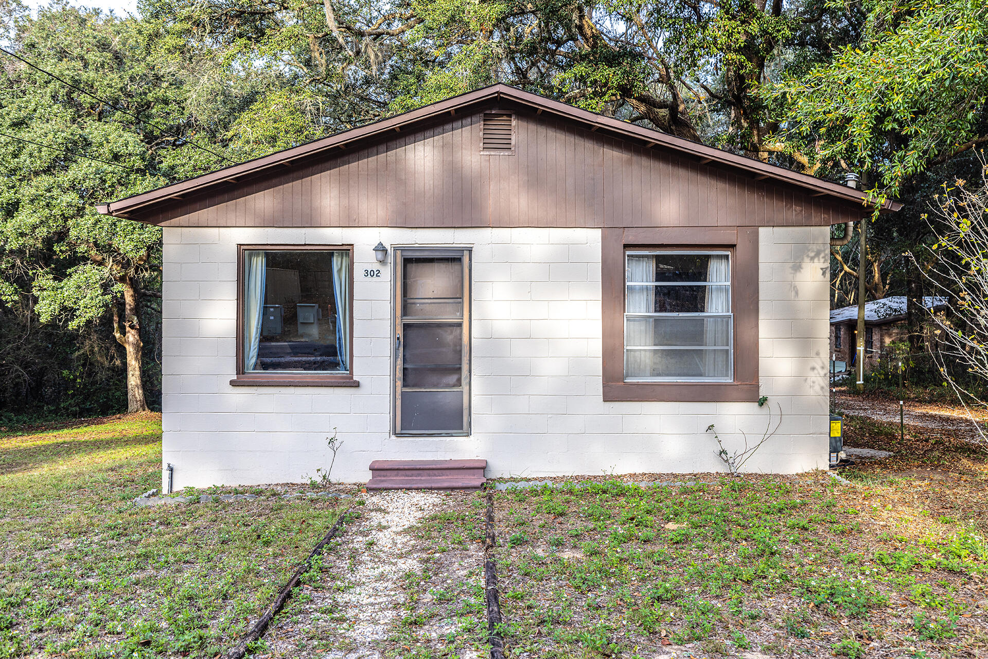 Rental investment property opportunity knocks in Niceville. Good bones, cottage style dwelling with a nice full basement area. Use the basement for storage, hobby or a craft area. (not heated or cooled) It's possible that the original wood flooring in the heated and cooled area could be under the carpet. Most major mechanics have been recently updated. Simple floor plan with kitchen having direct access to newly restored 12 x 16 wood deck complete with fresh primer coat and paint job. Deep lot is backed with dense woods for extra privacy. Work at Eglin AFB? Be home every day for lunch within 10 -15 minutes. Newly married? Great starter home. Single mom with a young child or teenager.... perfect opportunity.