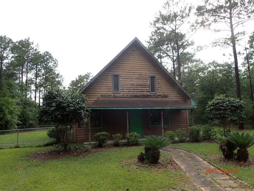 This REO home rests on just under 1 acre and is AFrame in style. Downstairs, the kitchen, living room, and dining area are on large room with high ceilings. Downstairs there are also 2 bedrooms and 1 bath. upstairs you will find a 3rd bedroom and 1/2 bath. Home needs repairs, and will not qualify for most financing. Back yard if fenced with chainlink and there is also a detached storage shed. Seller has priced this on to sell!