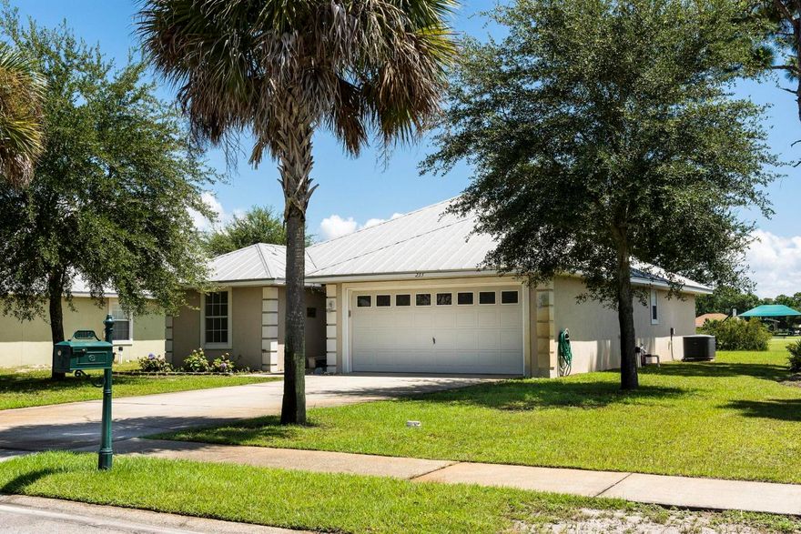 This Driftwood Estates home boasts vaulted ceilings, and updated textured ceiling (popcorn ceiling is removed). 1,484 square feet of living space with a split floor plan; master bedroom on one side with the additional two bedrooms on the other. The large master bath has an over sized tub and two sinks with plenty of space. The 2nd bathroom has a full tub and shower combination. Updated wood laminate floors complete the home against the white trim and light gray walls. The majority of lights are set up with dimmer switches allowing you more control of the room lighting. Ceiling fans in all three bedrooms as well as the living room. The back French doors open up to a view of the lake and neighborhood park which has a full kids playground, full basketball court, wall ball court,
