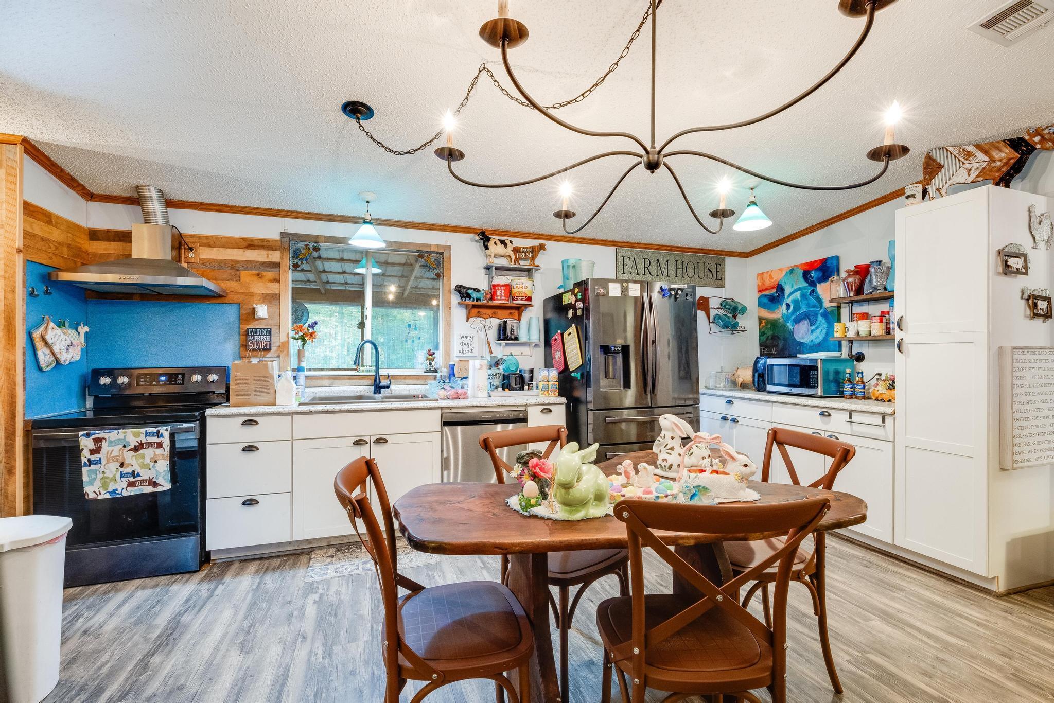If you are looking for a secluded home in the country, then you need to view this one! This unique and custom mobile home has a massive screened in porch so you can sit and enjoy the birds chirping, entertain guests, or simply enjoy a cup of coffee in a peaceful atmosphere on 2 acres surrounded by the privacy of woods and nature. There is a second building on the property being used as a tiny home , featuring a bedroom, sitting area, full bathroom, and a partial kitchen. There are also several structures on the property used for storage of campers or boats and even one used as shop with electricity.More pictures coming soon