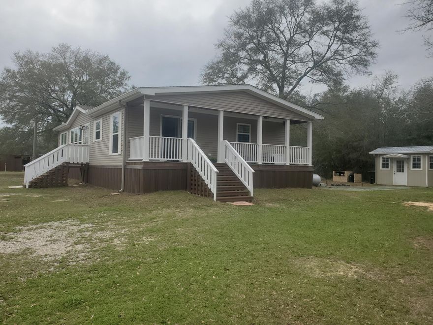 WHAT A FIND!  This home on one-acre is found just outside the city of DeFuniak Springs with easy access to Fort Walton Beach, Eglin AFB and the beaches.  The home is a 2022 manufactured home built to strict standards with fabulous upgrades. It features high-end products built to high energy-efficiency site-built home standards.  Home is set-up for gas stove and other appliances.   The one acre includes a greenhouse/garage, a bath house with travel trailer hook-ups, chicken house, dog run, barn and a hoop house.  The property is fenced with a front gate.  The land has irrigation and provides lots of vegetables from the raised beds.  Shown by appointment.  Buyer to verify all dimensions, schools, utilities and other matters of importance.
