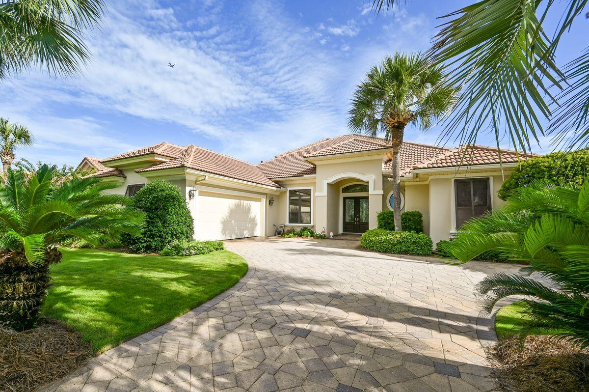 Welcome to this beautiful golf course home located in the gated community of highly sought-after Regatta Bay. Nestled on the 4th fairway, it enjoys a panoramic view of the course and a 63-acre nature preserve. As you enter the grand foyer through the double leaded glass mahogany doors, you are greeted by soaring 12' ceilings, extensive moldings, indirect lighting, and gleaming tile floors. The formal dining room boasts columned archways and a special display cabinet with a mirrored buffet. The formal living room provides the warmth of a ventless gas fireplace and a wall of sliding glass doors that lead to the spacious lanai and private pool area. The gourmet kitchen is a Chef's delight, featuring custom Arizona Alderwood cabinets, granite countertops, double ovens, double microwaves,