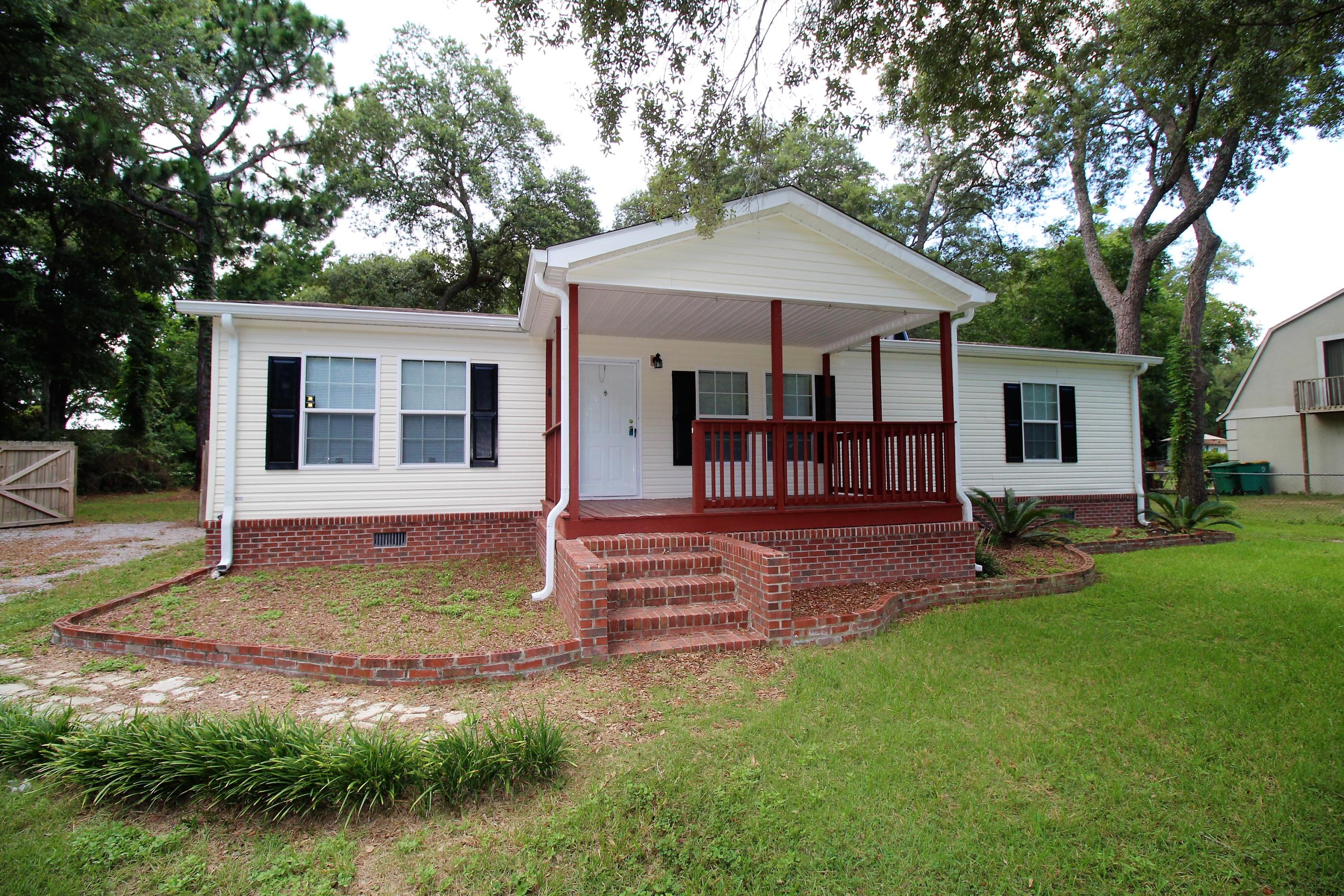 Well maintained & ready for a new owner. This 3 bedroom home has a little rustic vibe with custom log columns, cedar trim, and a wood burning fireplace. Large covered front porch and even larger rear deck overlook close to a 1/2 acre of fully fenced land. A double gate gives vehicle access to the workshop/carport in the backyard. The master bathroom is being redone with a walk in shower. Seller is open to completing the project or giving a credit at closing so a buyer can finish to their liking. **SELLER FINANCING POSSIBLE** All measurements approximate.