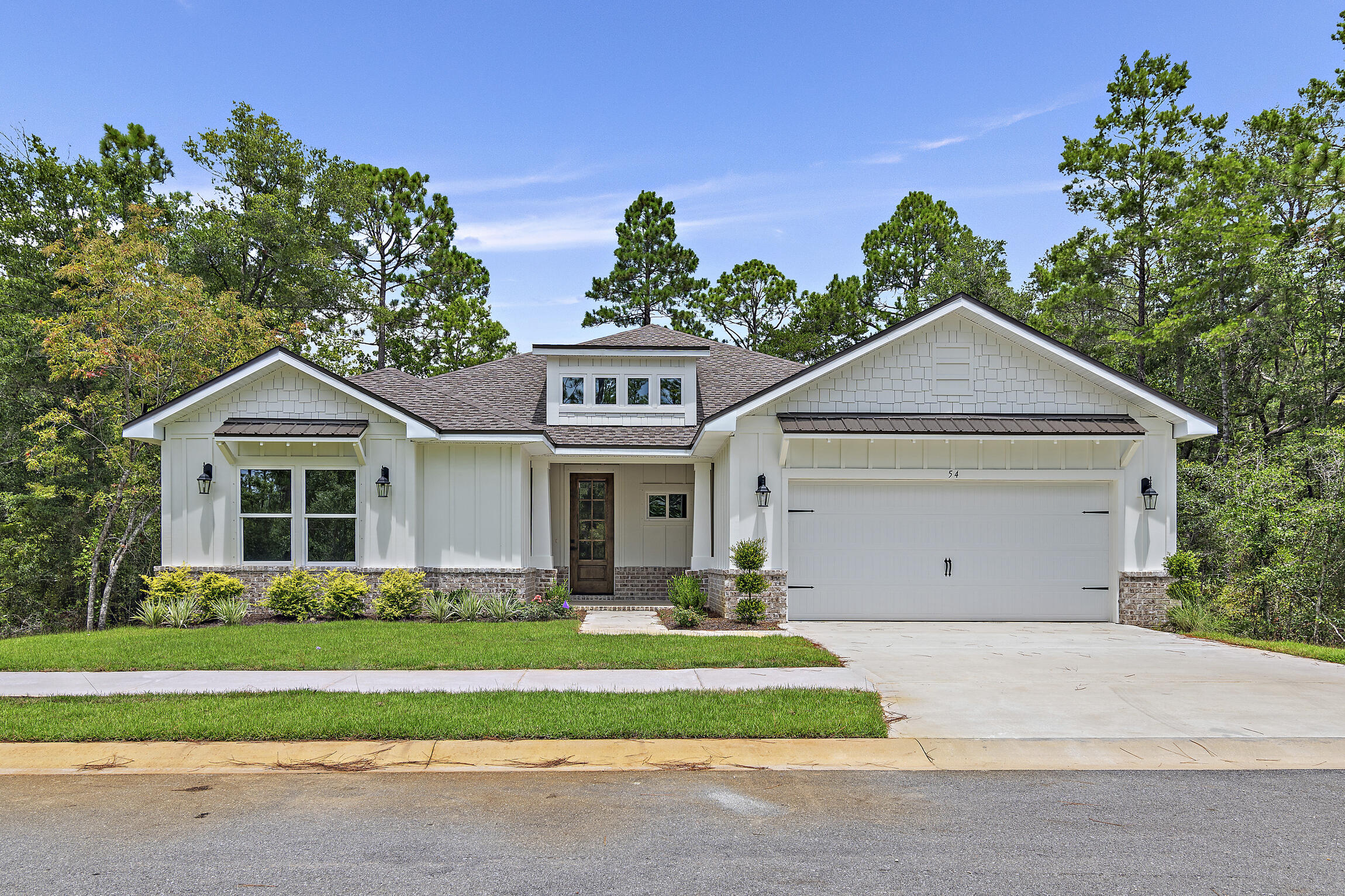 Experience luxury in this new 4-bedroom, 2.5-bathroom, one-story home in Bear Creek, with one bedroom ideal as a study. Upscale finishes include an electric fireplace, LVP and tile flooring, crown molding, white cabinetry with ceiling-high glass stacks, a farmhouse sink, and white quartz countertops with a waterfall feature. The home is conveniently located steps from the Phase 3's amenity center and backs up to a serene community green space with a creek and mature hardwoods. Bear Creek offers amenities such as pickleball, tennis, basketball, a fitness center, and a pool. Phase 3's amenity center will add a second pool and four more pickleball courts. Just over the 331 bridge, Bear Creek's prime location is minutes from the Beaches of South Walton, parks.