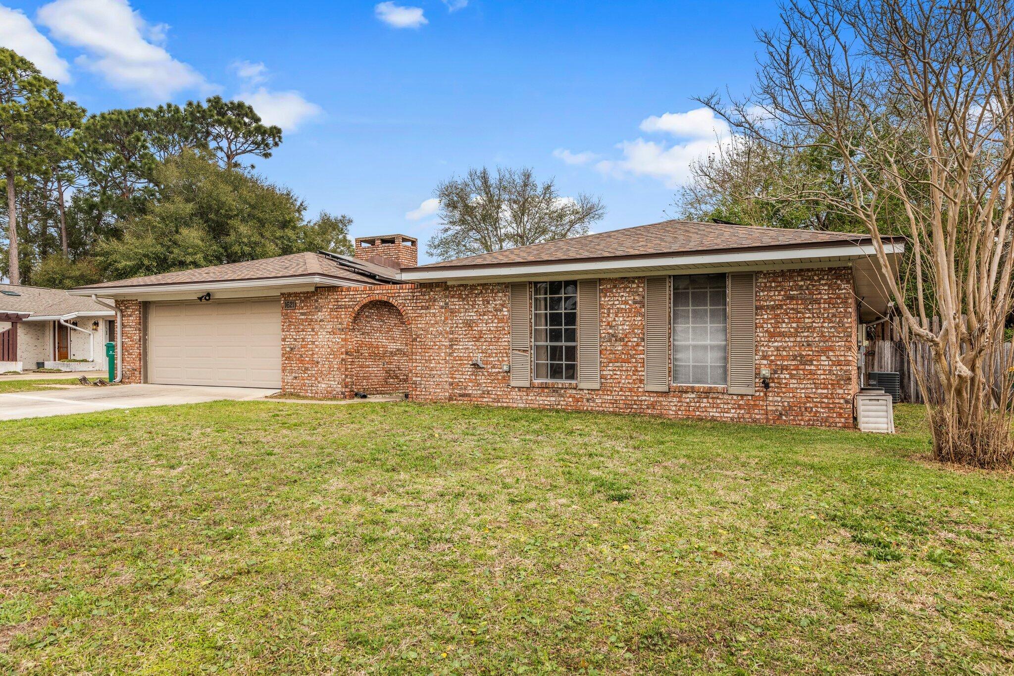 Come see this four bedroom two bath home today! The open floor plan has hardwood flooring throughout the kitchen, dining and living areas as well as the master bedroom and hallway. The kitchen has stainless appliances and the large great room has crown molding, a wood burning fireplace and french doors that lead to an open patio in the fully fenced backyard. Both bathrooms have been updated with new cabinetry, countertops, sinks and lighting. The master bath has a separate tiled shower with pebble stone floor. Other features include gutters, water softener and solar panels which reduce or eliminate electric bills. Roof is 2019 and HVAC 2009.