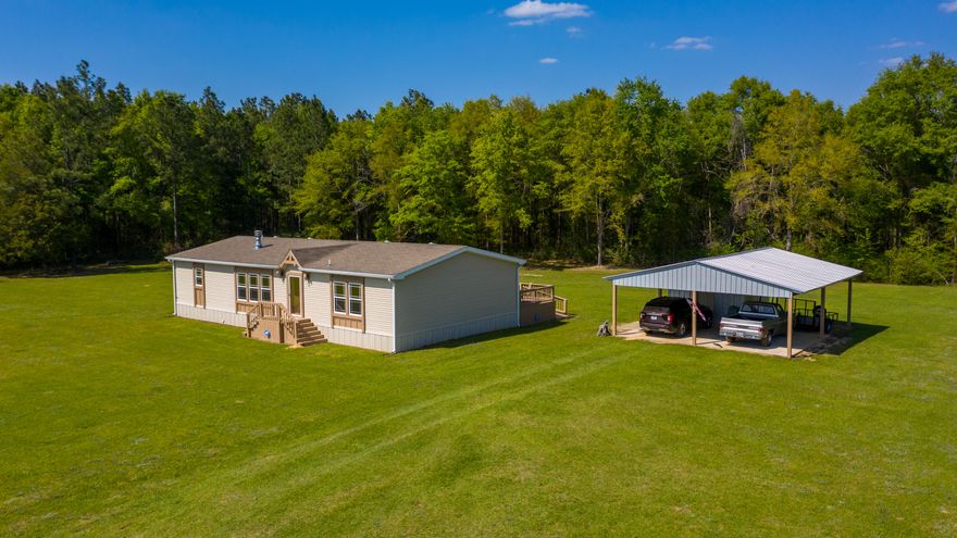 LOOKING FOR A GREAT HOME IN NORTH WALTON COUNTY - THIS 3 BR 2 BA LIKE NEW MANUFACTORED HOME SITTING ON 5.7 ACRES HAS IT ALL! CUSTOM BUILT TO ZONE 3 STANDARDS, LARGE OPEN FLOOR PLAN, AND A LARGE BACK DECK LEAVES NOTHING TO DESIRE. HOME WELCOMES YOU WITH A LARGE OPEN CONCEPT OF THE LIVING ROON, DINING AREA, AND KITCHEN THAT ALLOWS PERFECT ENTERTAINING. THE MASTER SUITE IS AMAZING WITH A LARGE MASTER BATH THAT INCLUDES WALK IN SHOWER, LARGE WALK IN HIS AND HER CLOSET, AND DRESSSING AREA. HOME HAS 2 ADDITIONAL BEDROOMS THAT ARE PERFECT SIZE FOR YOUR FAMILY. HOME HAS ALL THE EXTRAS AND IS INCLUDED IN DOCUMENT SECTION.  A LARGE DETACHED CARPORT WITH STORAGE AS WELL. PART OF PROPERTY REMAINS WOODED. EASY COMMUTE TO CRESTVIEW OR EGLIN AFB. JUST OUTSIDE OF TOWN WITH A GREAT COUNTRY FEEL!