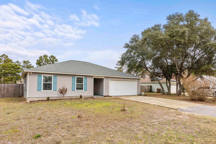 Welcome Home! This adorable home boasts 3 bedrooms, 2 baths, & an open floor plan that creates a warm & inviting atmosphere. As you step inside, you'll be greeted by stylish plank tile flooring that stretches throughout, providing both durability and aesthetic appeal. Soft, plush carpet in the living room & bedrooms adds an extra layer of comfort.  The updated kitchen features sleek granite countertops, ss appliances, & soft-close drawers & cabinets. The master bath boasts a stunning tile walk-in shower for a luxurious experience. Situated on nearly half an acre with no HOA, this property offers ample space for outdoor enjoyment. The fully fenced backyard provides privacy and is perfect for entertaining guests & is RV accessible w/ RV hookups. See documents for a list of all updates.
