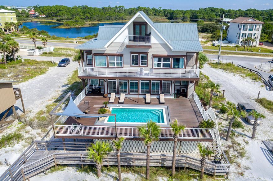 Looking for a well maintained home with expansive GULF VIEWS at a reasonable price? A WELL DESIGNED FLOOR PLAN with forever GULF VIEWS and COASTAL DUNE LAKE VIEWS, over a large HEATED POOL with AMPLE SPACE for friends and family to gather, is a home to see. This impressive 4 story beach home is located on the South Side of Scenic Corridor 30A with close proximity to Grand Blvd. and Destin. With 6 bedrooms/flex space,4 Full Baths, 2 CAR GARAGE, RV HOOK-UP & still more parking. The house has been TOTALLY RENOVATED and decorated with an established rental income of just under $200,000/year, in place. NEW HVAC and NEW ROOF 2018.There is MORE: The property adjacent to the east is owned by the County and cannot be built on! This means forever views & breezes without obstruction.