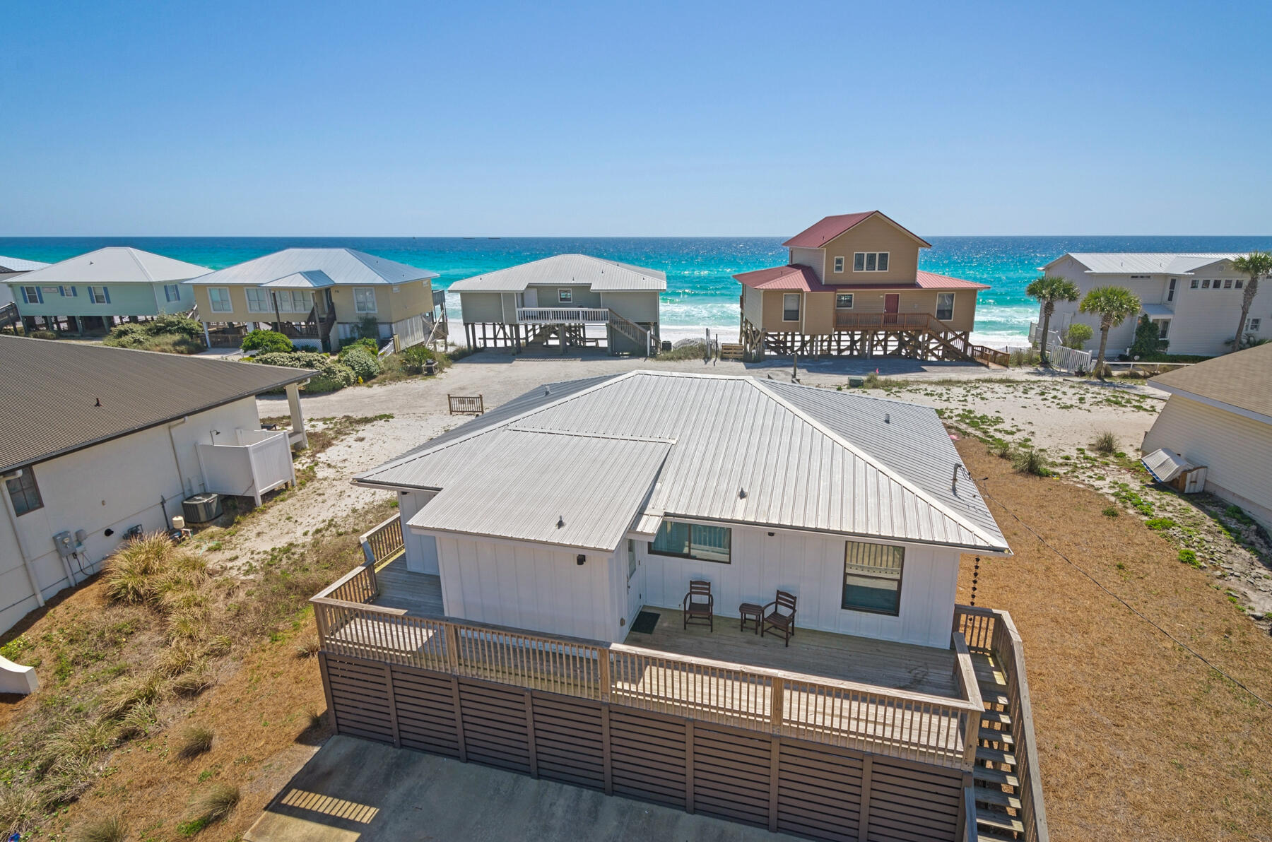 LOWEST PRICED HOME SOUTH OF 30A WITH GULF VIEWS & BEACH ACCESS. Coastal chic cottage one tier off the beach on the West end of 30A. Single floor living features an open kitchen-dining-living area all with gulf views. Four bedrooms and two full baths. This home was taken down to the studs in 2015 and completely renovated. The public beach access is at the East end of Fort Panic Road. The lot size of 80 x 150 should accommodate a pool in the rear. Views of one of 30A's rare coastal dune lakes from the kitchen and gulf views from 2 bedrooms and living area. This lovely home is currently used as a vacation rental and may be subject to bookings in place.