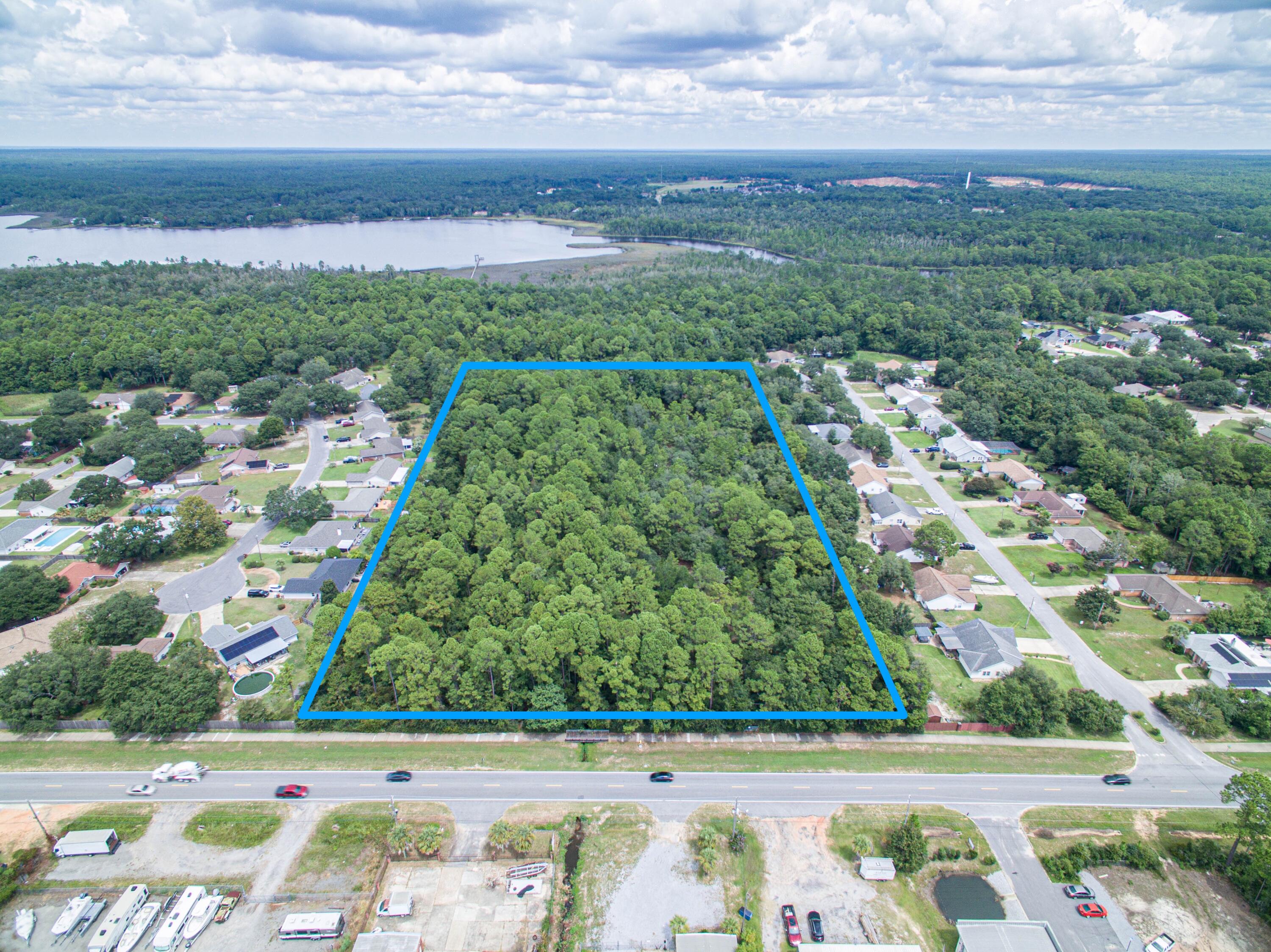 Back up offers being taken. Almost 10 acres on East Bay ready for your imagination. Two parcels being sold together. Both sides of the parcels have beautiful subdivisions. Zoned R-1 these parcels would make a great subdivision. The rear of the property has a MAN-MADE pond with a deep well and beautiful, old live oak trees. Only 1/2 mile from the intersection of 87 and 399.The property is believed to have some wetlands however would need to be verified by the buyer.
