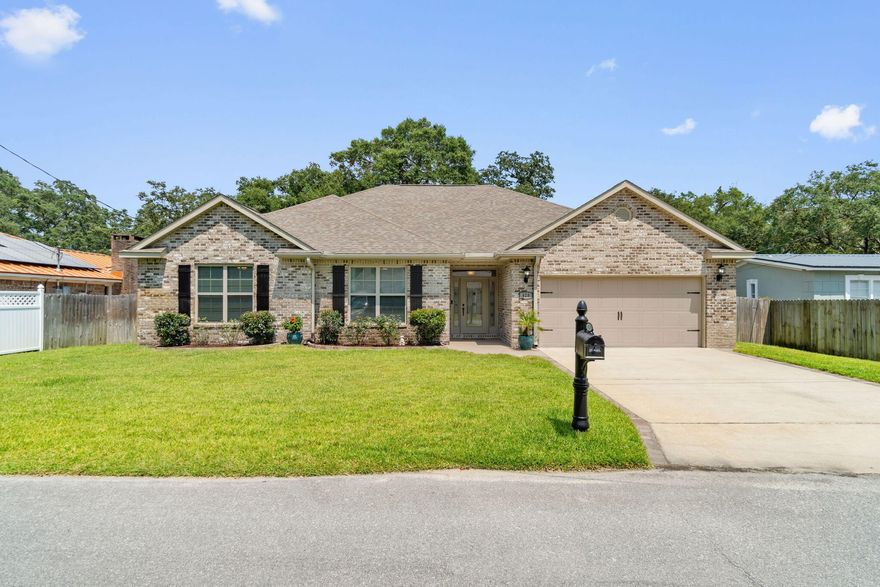 Welcome to 428 Walters Circle, a remarkable executive home that blends upscale living with a casual and comfortable feel - truly A PLACE YOU WILL WANT TO CALL HOME. Built in 2019 to current hurricane standards, this immaculate all-brick residence offers 4 bedrooms, 2 baths, wood look plank tile flooring throughout except the bedrooms, and 2,108 square feet of well-designed living space, on a beautifully landscaped lot.  Step inside, and you'll be greeted by a welcoming foyer leading to an open concept living/dining and kitchen area. The kitchen is a cook's dream, boasting granite countertops, a kitchen island with power, stainless steel appliances, and a large breakfast bar for additional seating. Enjoy delightful meals in the eat-in dining area, which features double windows offering a view of the picturesque backyard.  The oversized living area with a tray ceiling, ceiling fan, and French door that leads to an expansive covered porch, perfect for savoring your morning coffee or relaxing with a glass of wine while enjoying the serene water feature and lush landscaped backyard beneath the shade of Southern live oak trees.  The master bedroom is a spacious retreat with a tray ceiling, ceiling fan, new upgraded carpet, and a walk-in closet. The master bath pampers with a dual sink vanity featuring granite countertops, a separate shower, a garden soaking tub and separate water closet.   Generously sized guest bedrooms share a large guest bath with a dual sink vanity and granite countertop. Conveniently located off the master bedroom, the laundry area is easily accessible by the guest bedrooms. The 2-car garage has been thoughtfully transformed with a beautiful epoxy floor, finished walls and baseboards, adding to the overall appeal of the home.  Outside, the yard is easy to maintain with an irrigation system supplied by a deep water well.  A yard building on the side of the residence for extra storage conveys as is. GREAT LOCATION centrally located to most conveniences: schools, medical, shopping, restaurants, entertainment and minutes from Eglin AFB, Hurlburt Field and our white sandy beaches. This home is loaded with thoughtful upgrades, including Levolor blinds on all windows, cushion close drawers to lower kitchen cabinets, soft close cabinet doors, brick pavers added to create a patio and enhance the covered porch, drive way, walk ways, and even a dedicated trash can spot, interior recently painted with quality Behr paint in neutral color, extended gutters and added leaf screens, installed cabinets in the laundry area, added under cabinet lighting in the kitchen, painted the front and back porch areas with Behr Granite Grip paint, installed ultra quiet Whirlpool dishwasher, and new GE microwave. You'll find this property is not only comfortable for everyday living but also perfect for hosting large family and friend get-togethers. The stunning features and upgrades make it stand out from the rest. Don't miss the opportunity to make it yours. See the LIST OF IMPROVEMENTS under documents and explore our virtual tour to fully appreciate all this home has to offer. BUYER TO VERIFY ALL DIMENSIONS AND ANY INFORMATION THEY DEEM IMPORTANT.
